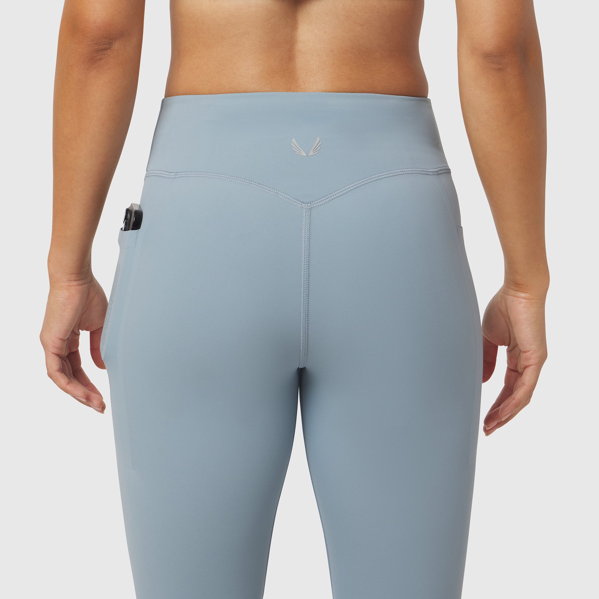 Light Sky LYCRA® ADAPTIV 4 Pocket Legging worn by model, back view showing side pocket