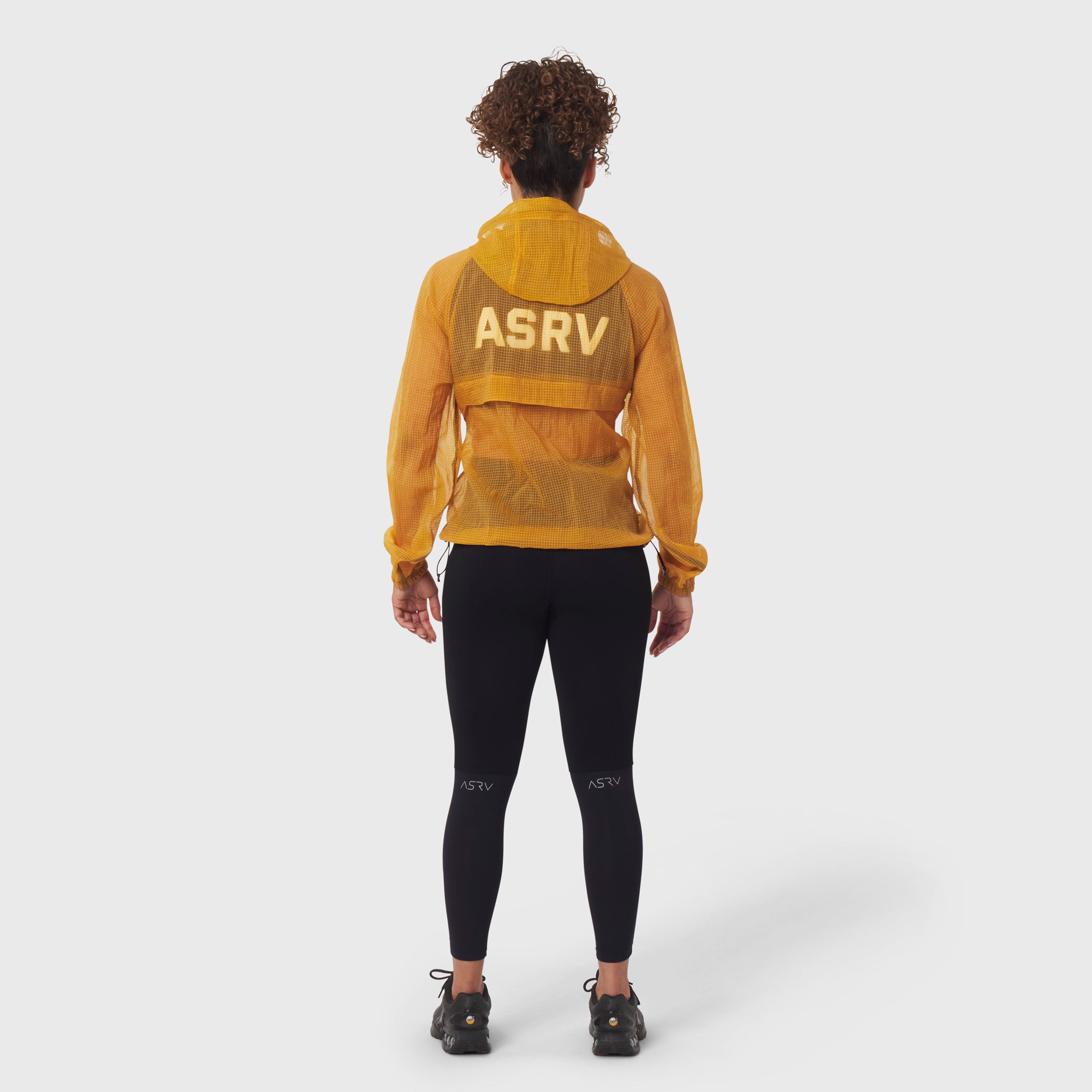 Weather-Ready Transparent Ripstop Shell Jacket in amber, worn by model from behind