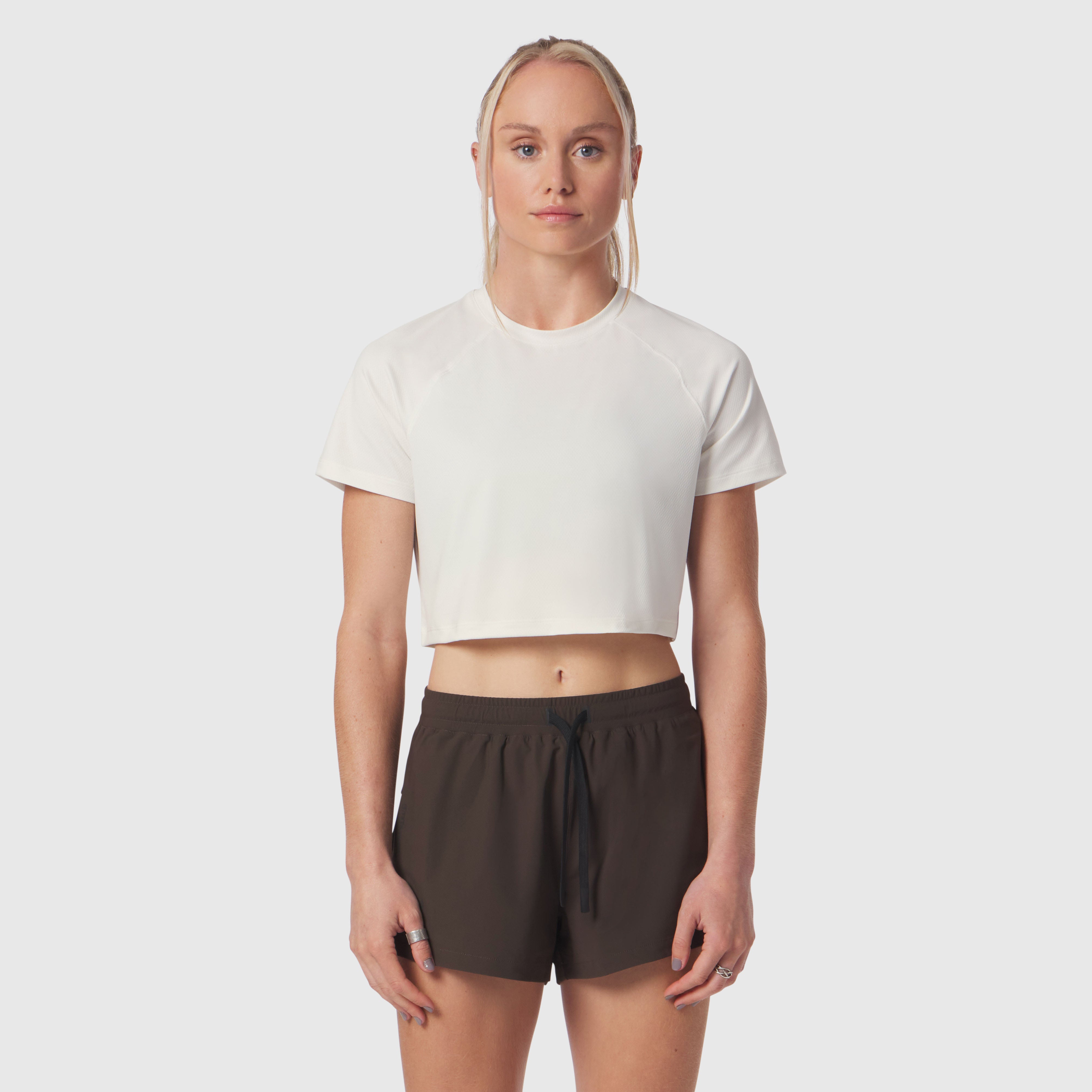 AeroSilver Cropped Tee in ivory cream worn with black shorts, front view