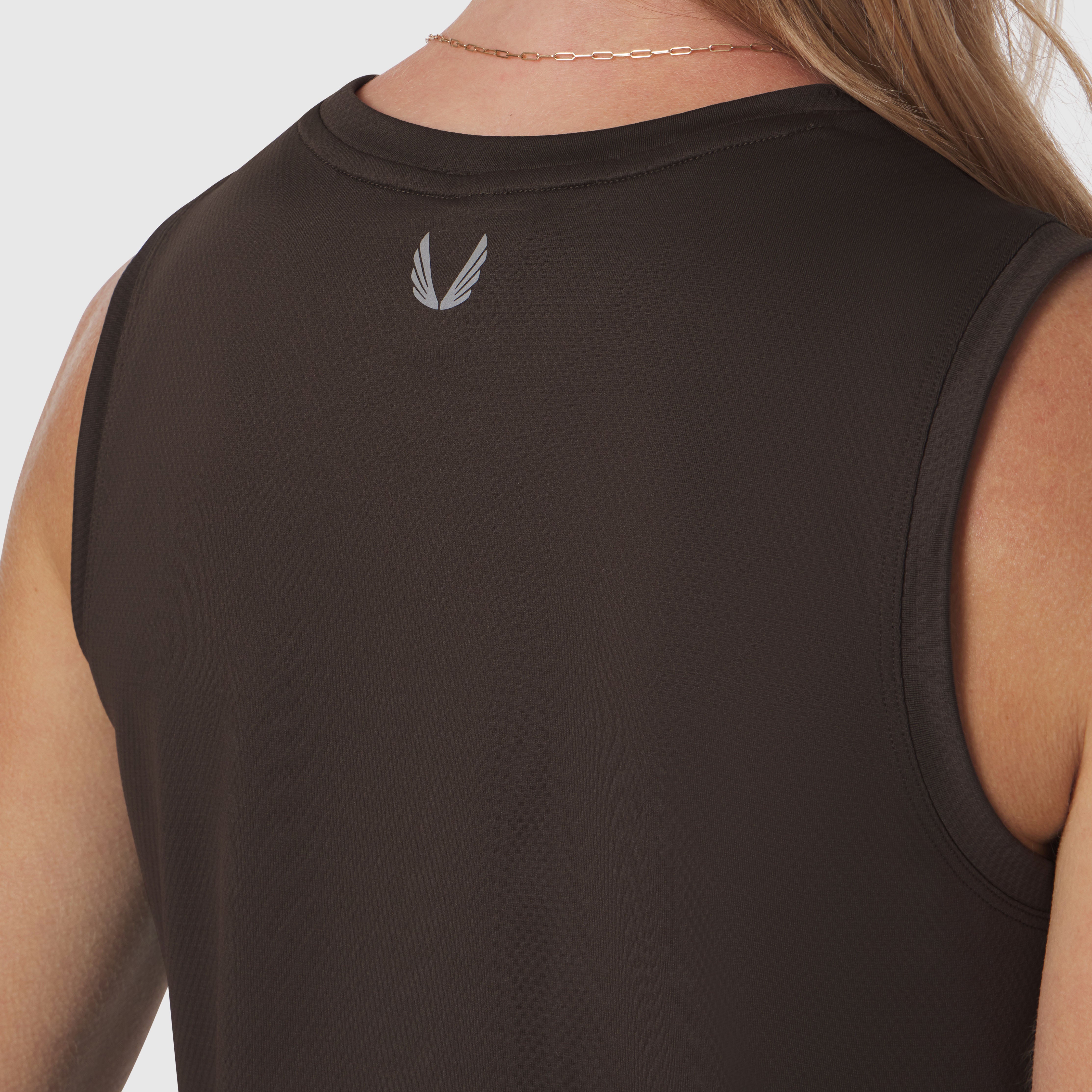 AeroSilver® tank top in dark earth worn by model, back view showing wing logo