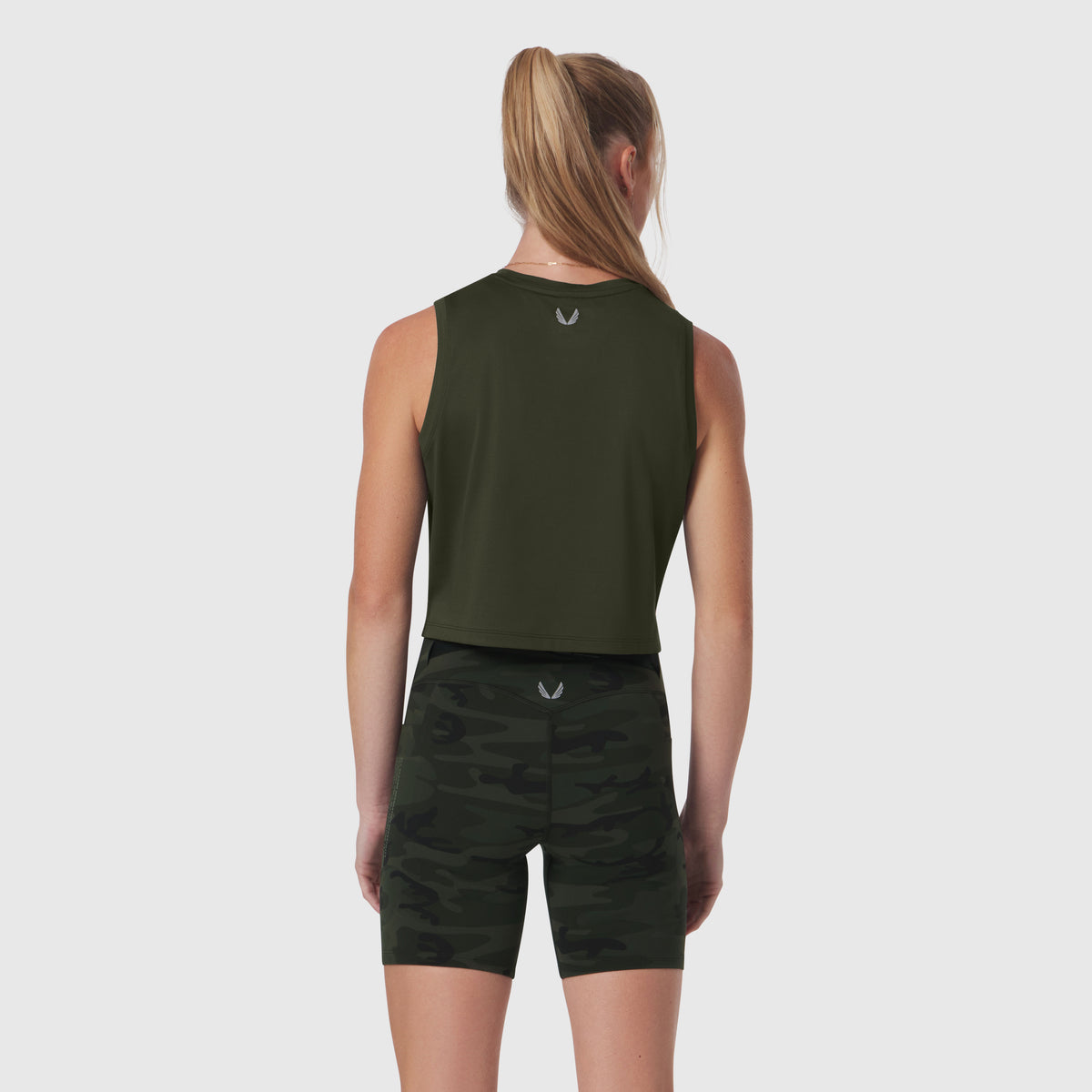 AeroSilver® Tank Top in olive worn with black camo shorts, back view