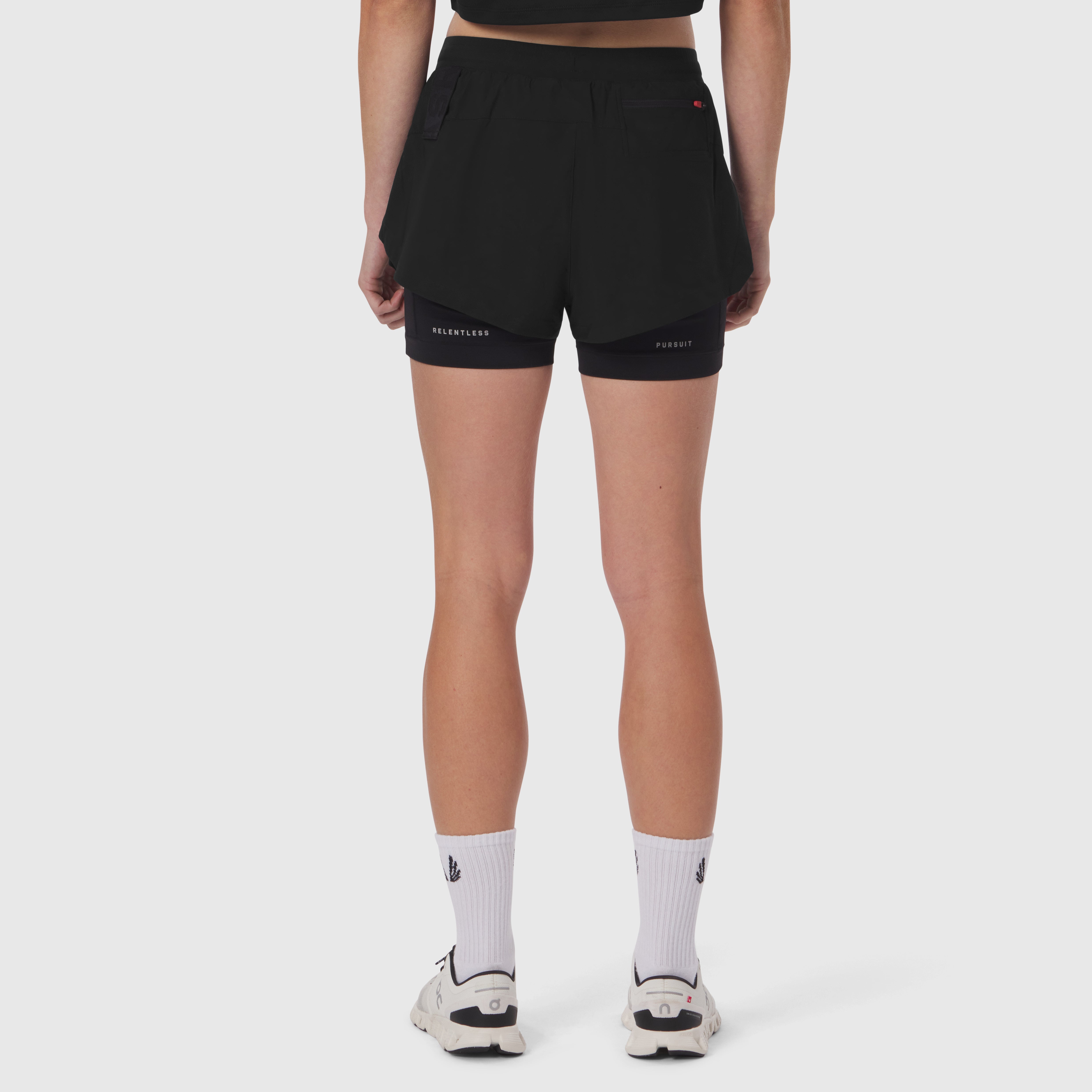 Tetra-Lite Liner Short in black, back view on model with white socks and sneakers