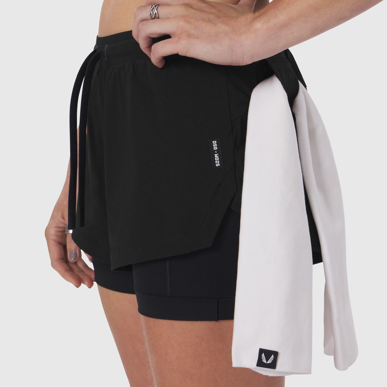Tetra-Lite Liner Short in black worn by model, side view with matching light gray overshirt