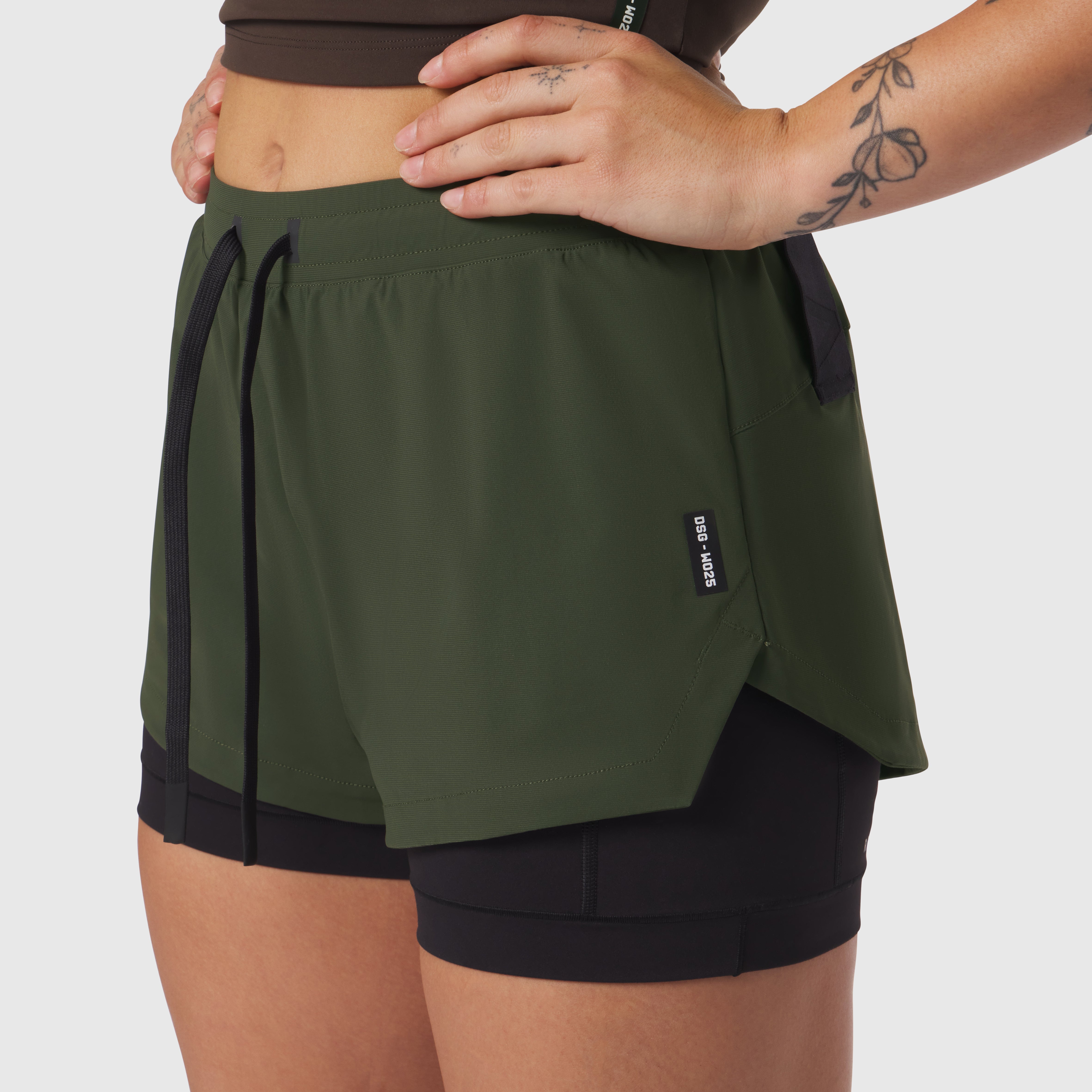 Tetra-Lite Liner Short in olive with black undershorts, worn by model with hands on hips