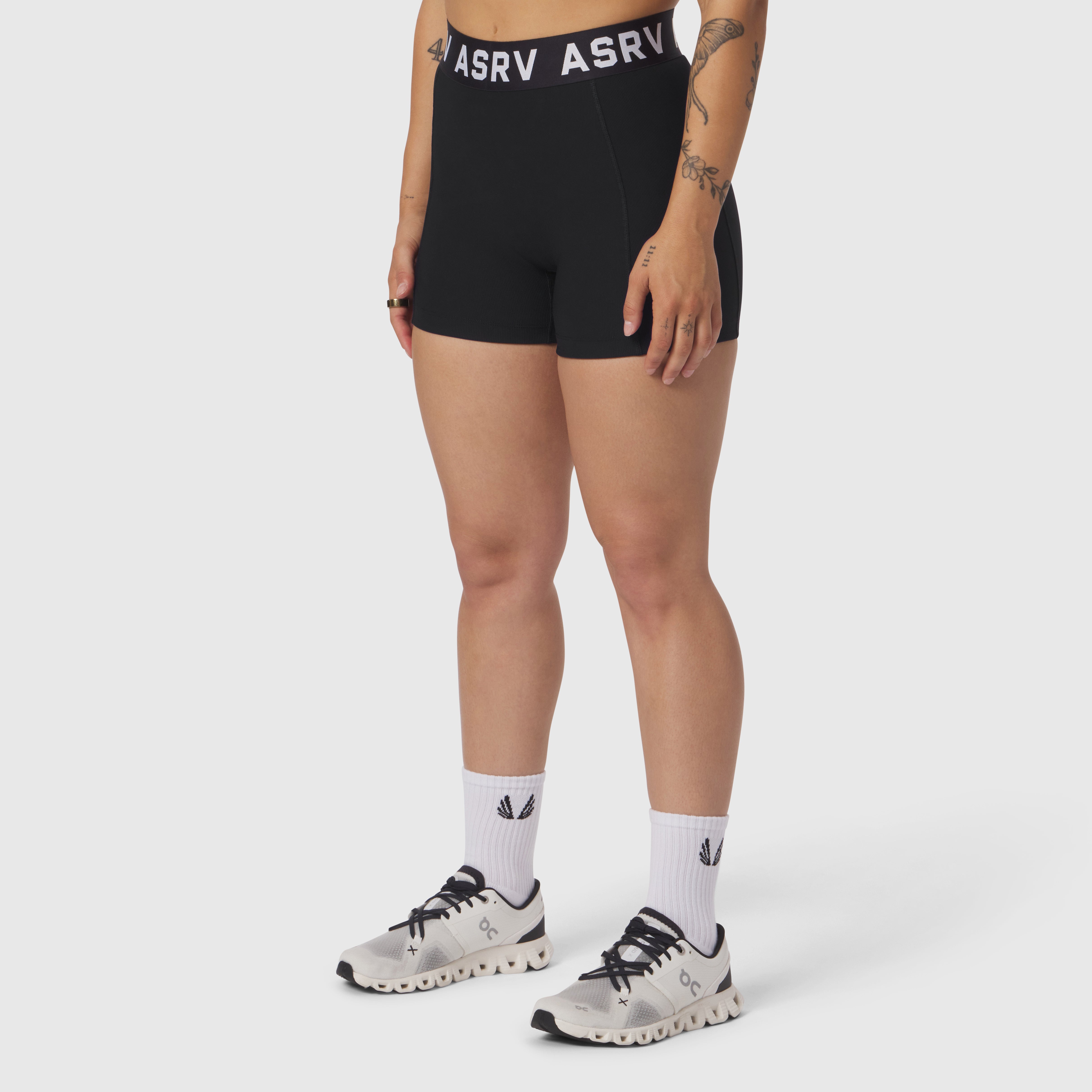 ASRV Lycra Ribbed Short in black, worn with white socks and sneakers, front view