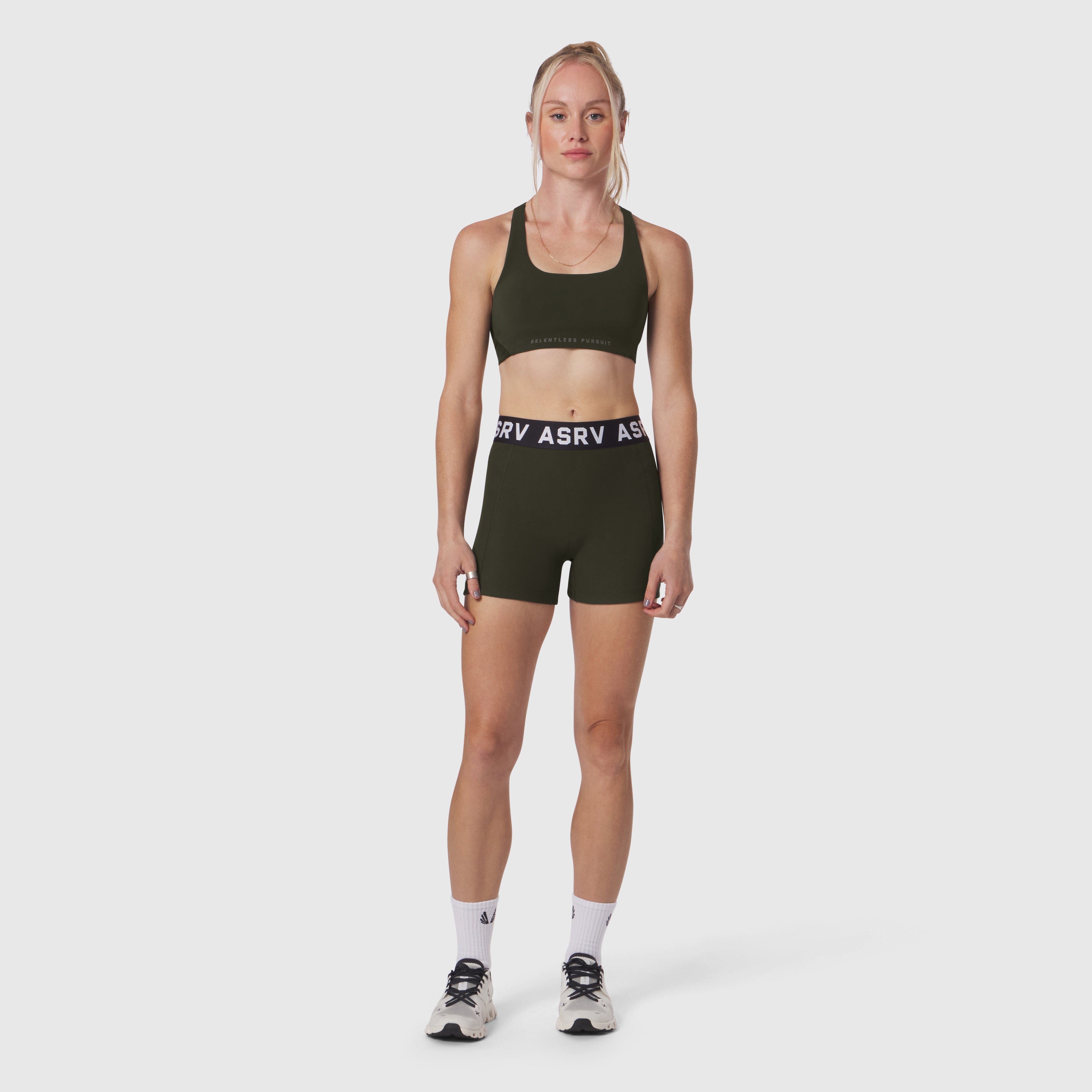 W027 Lycra Ribbed Short in olive, worn by model with sports bra, front view
