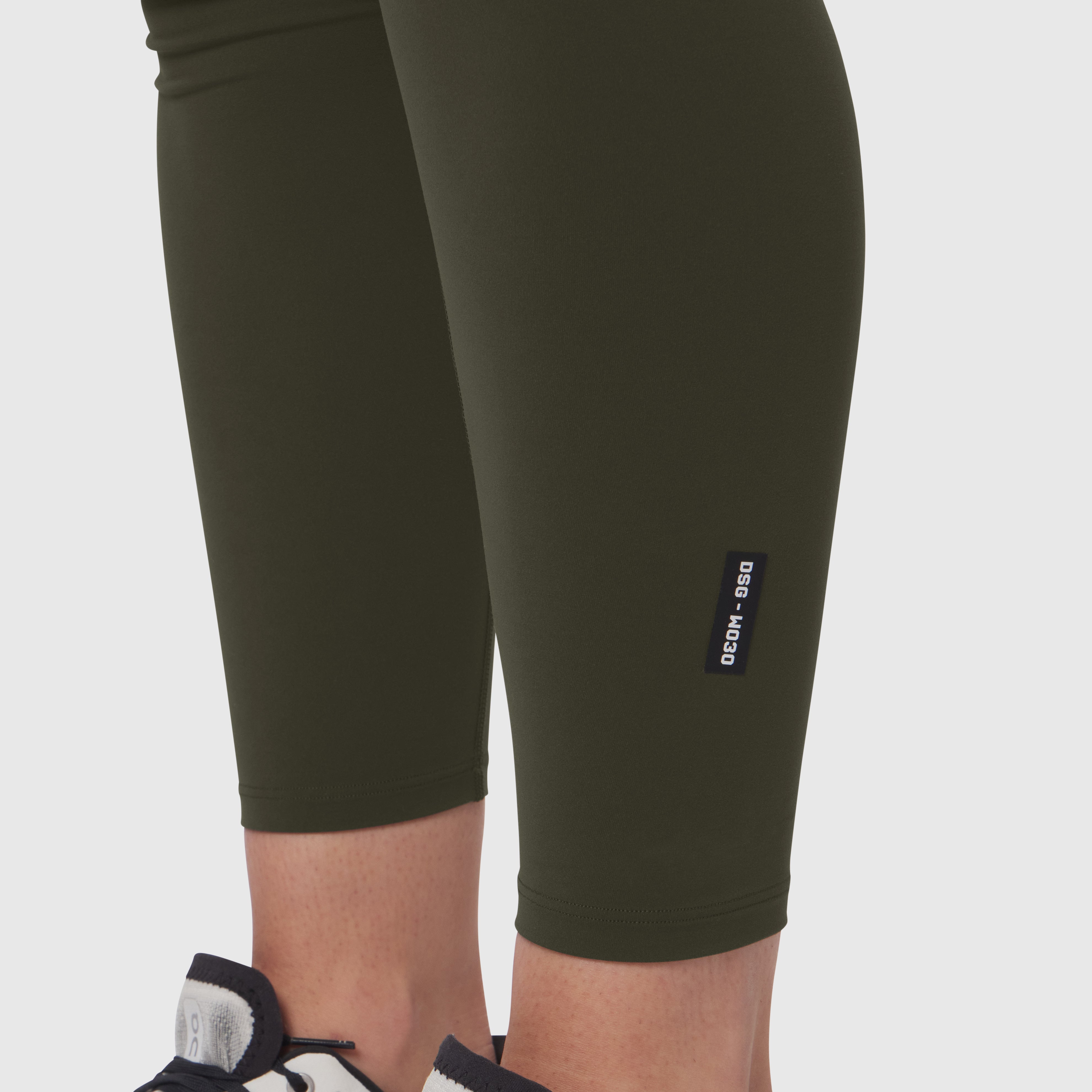 W030 LYCRA® 3-in-1 Legging in olive worn by model, cropped leg view
