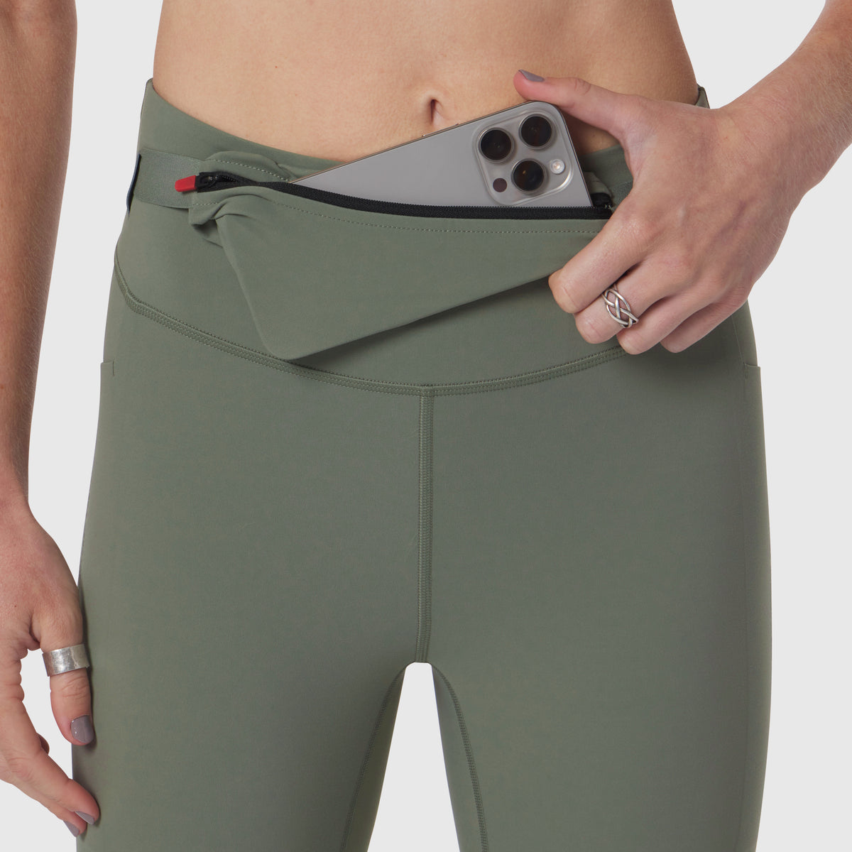 LYCRA® 3-in-1 Legging in sage, model wearing and displaying waistband pocket