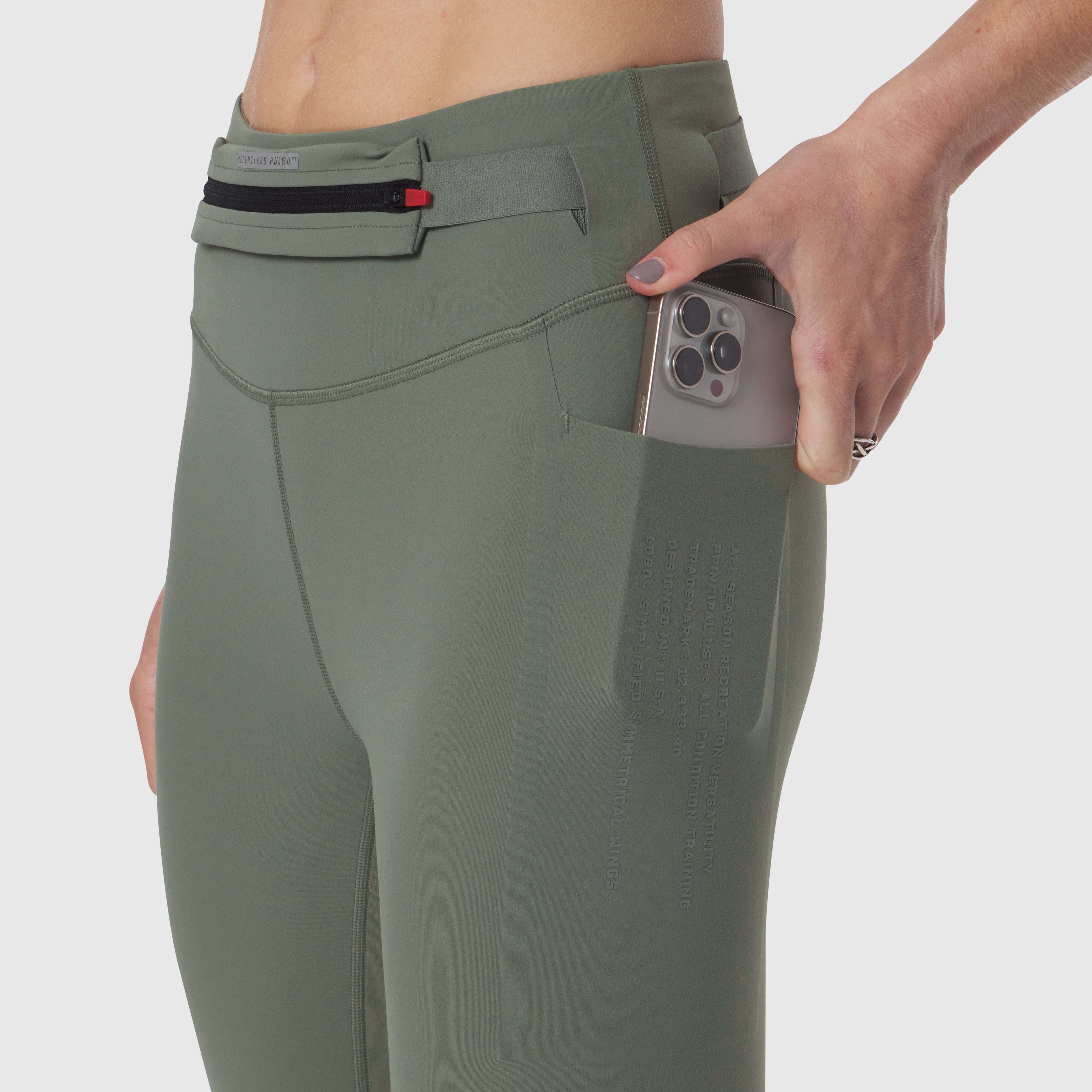 W030 LYCRA® 3-in-1 Legging in Sage, model holding phone in side pocket