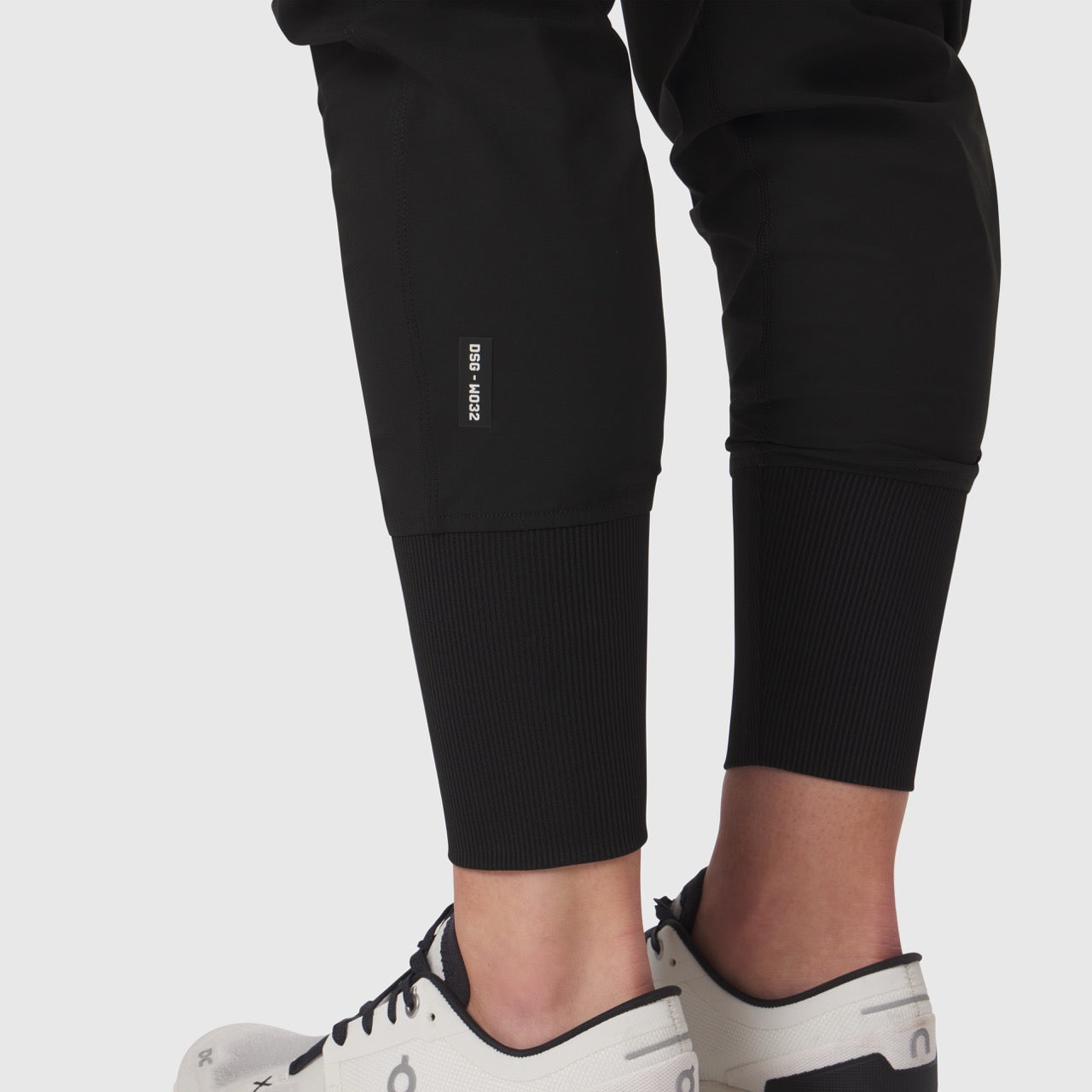 Tetra-Lite Cargo High Rib Jogger in black, worn with white sneakers, cropped view