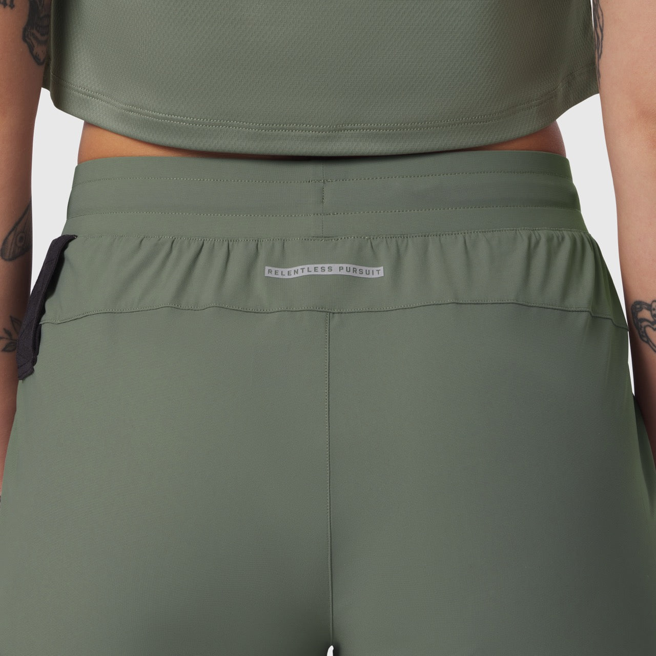 Tetra-Lite Cargo High Rib Jogger in sage, worn by model, back waistband detail view