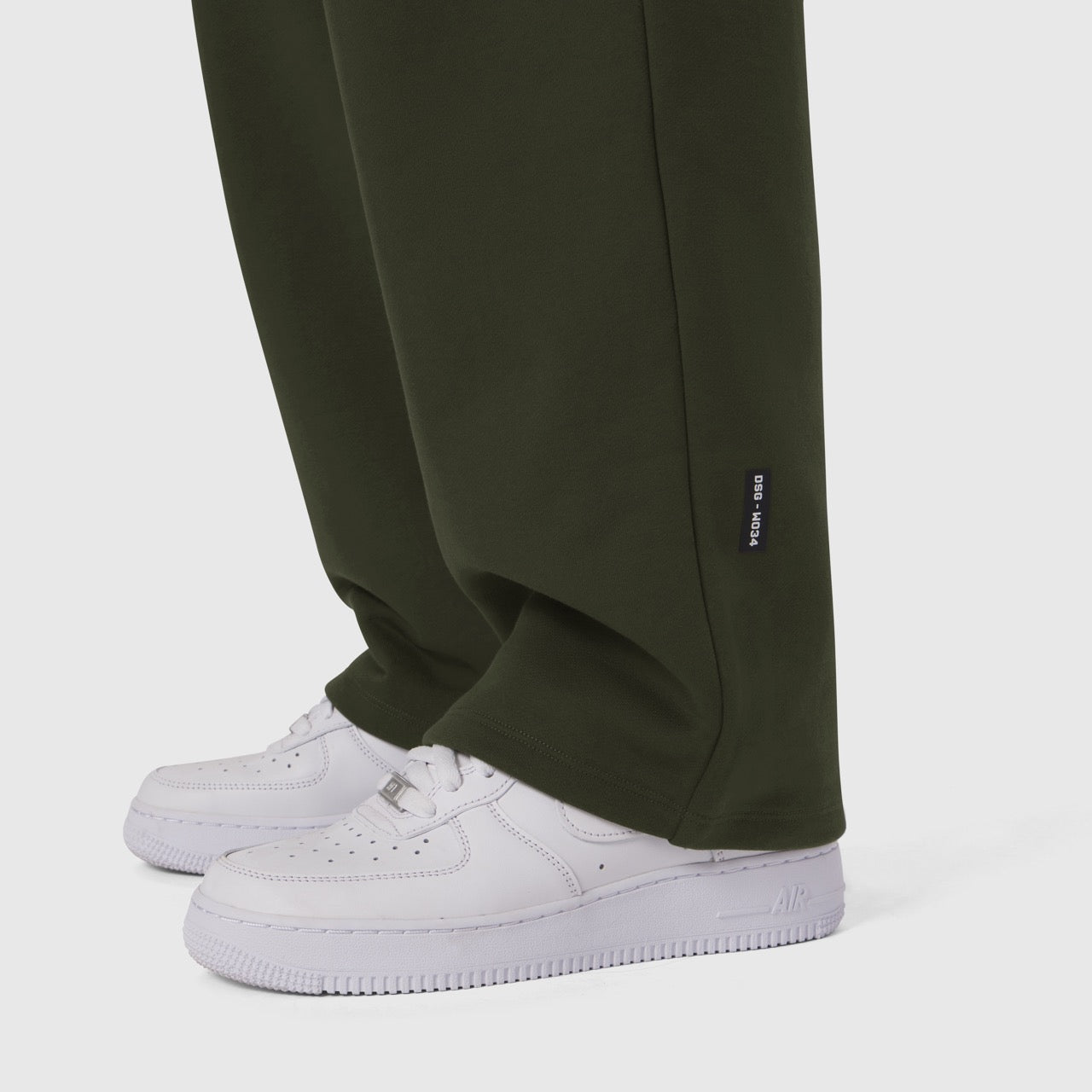 Olive Sorona® Terry straight leg sweats on model wearing white sneakers, cropped leg view
