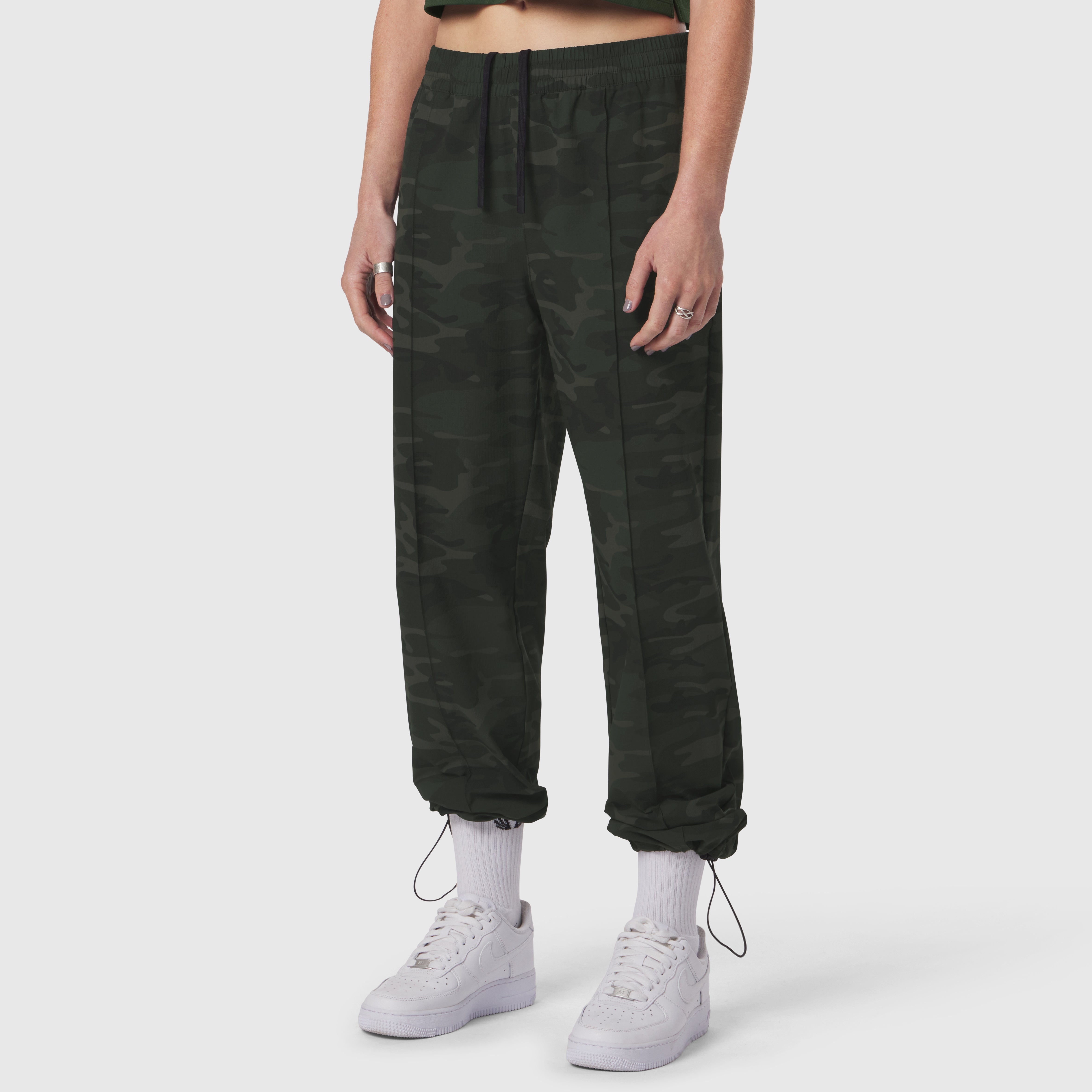 W036 Ripstop Relaxed Track Pant in dark camo, worn with white sneakers and socks