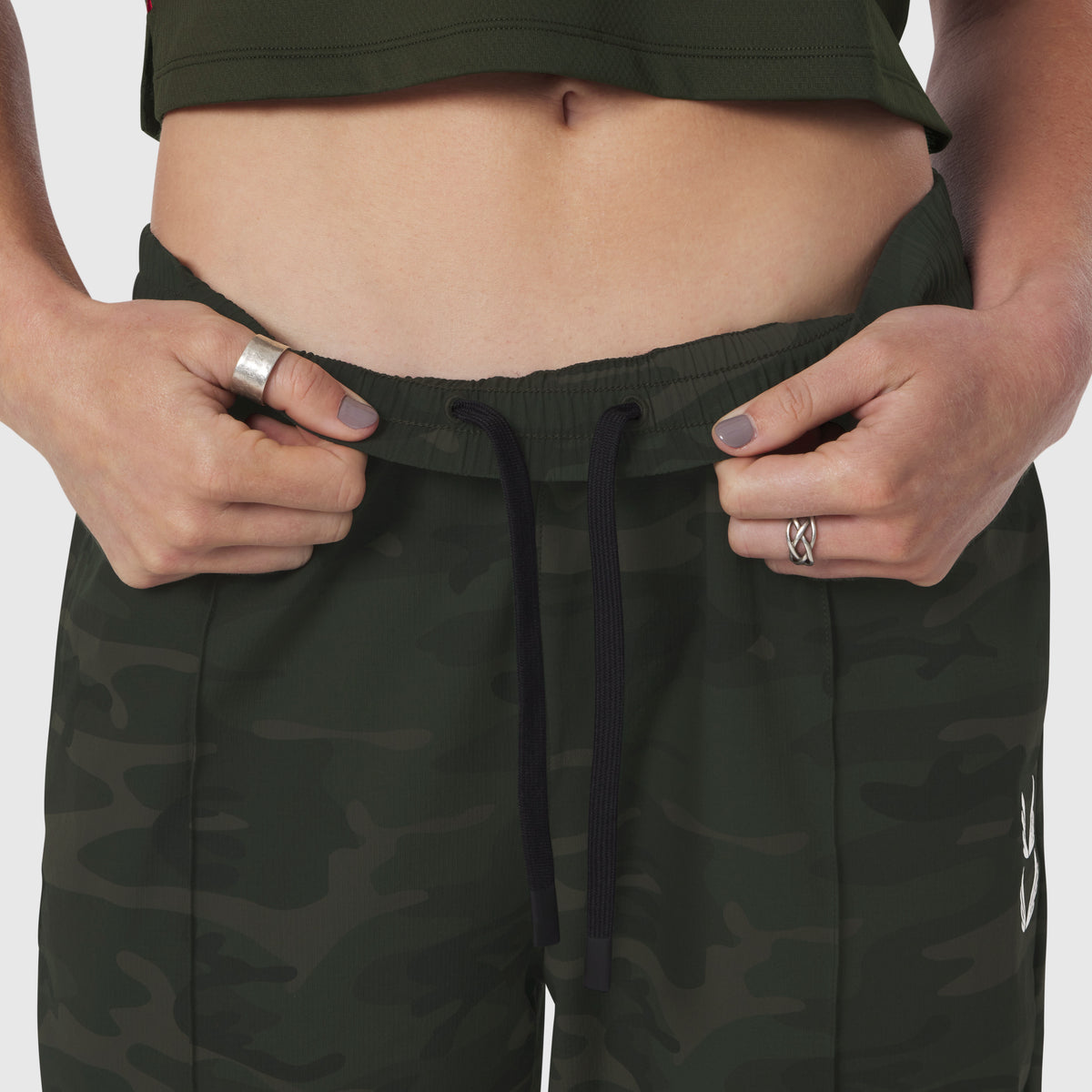 W036 Ripstop Relaxed Track Pant in Dark Camo, model wearing and adjusting waistband