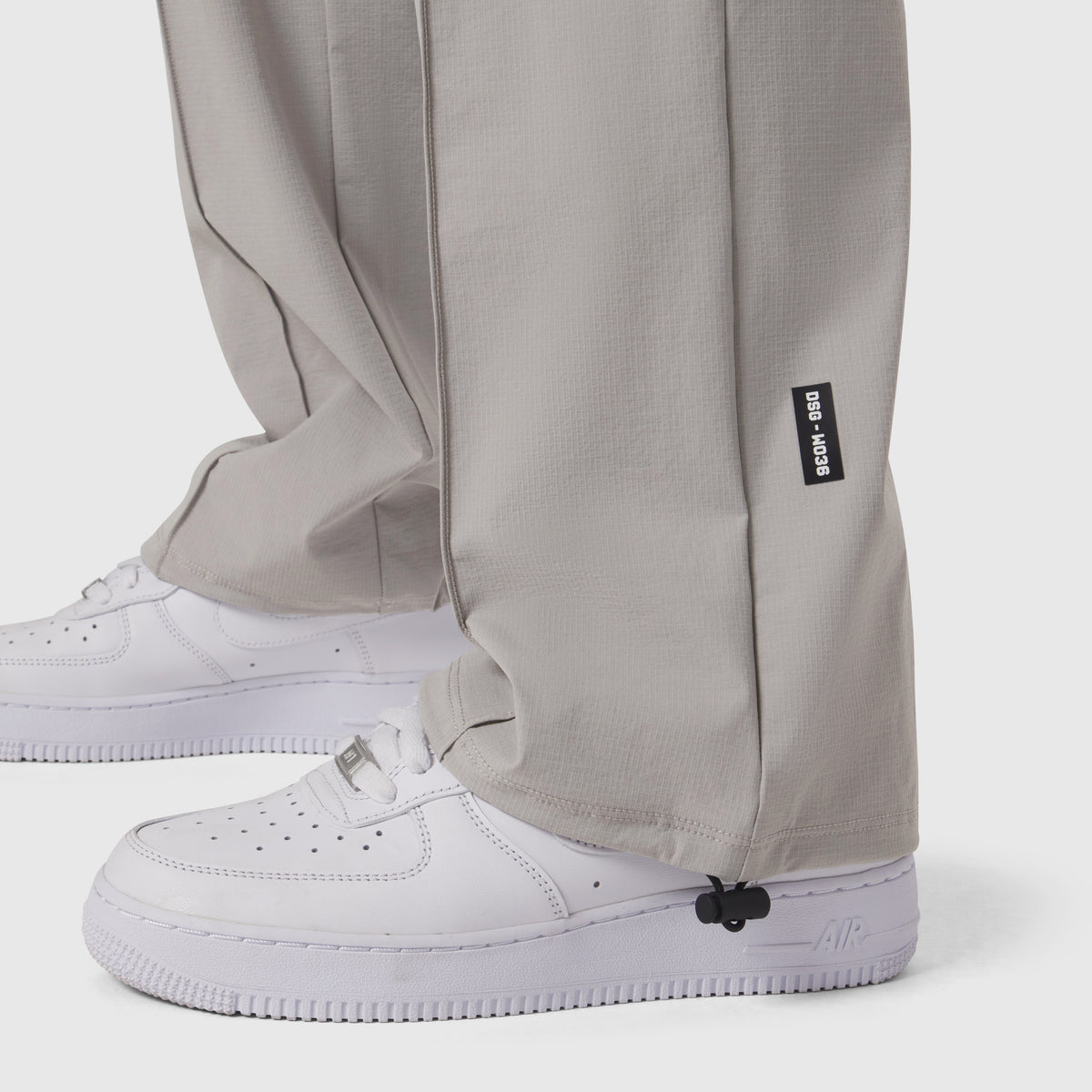 W036 Ripstop Relaxed Track Pant in slate grey worn with white sneakers, detail view of ankle cuff