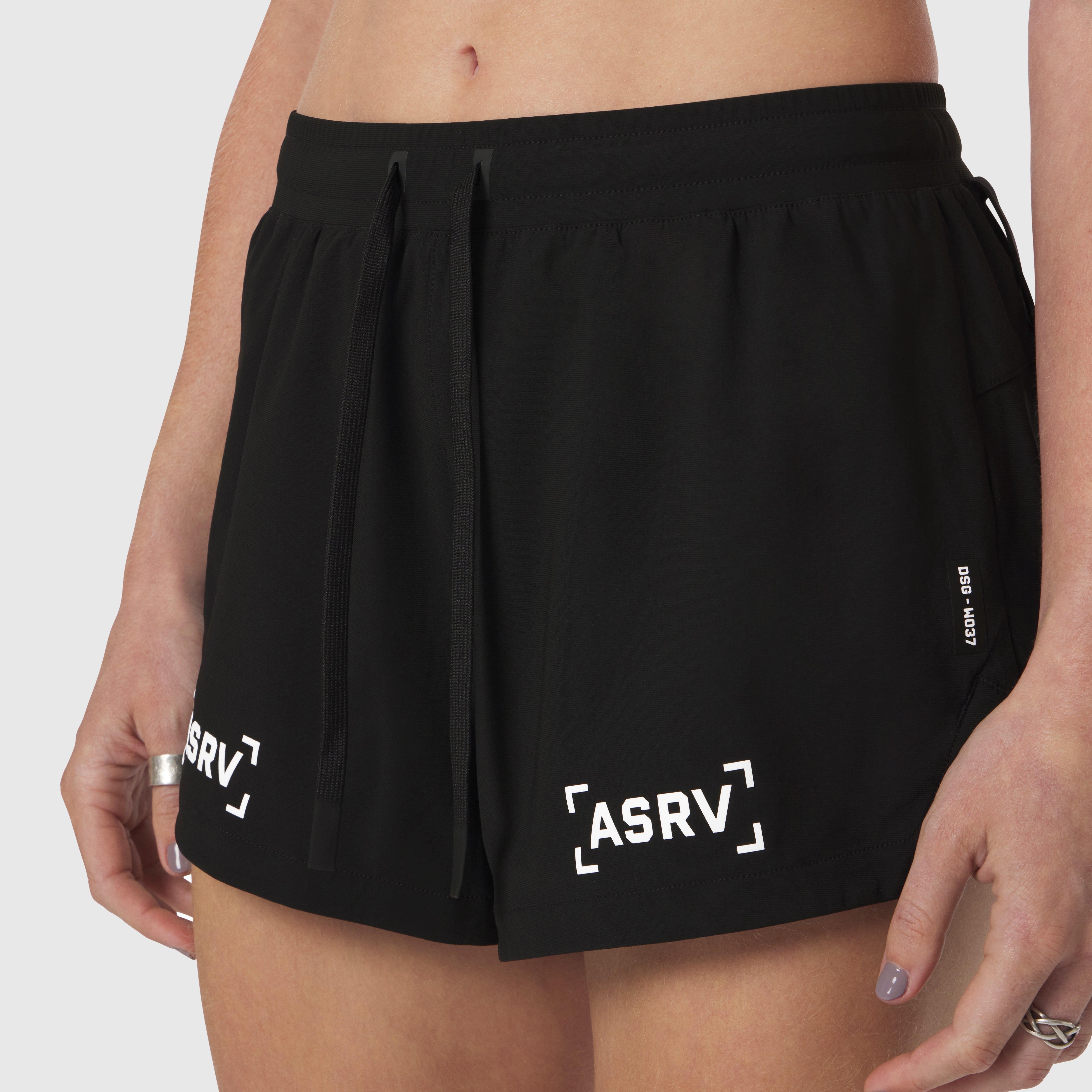 Tetra-Lite Linerless Short in black with 'Bracket' logo, worn by model, front view