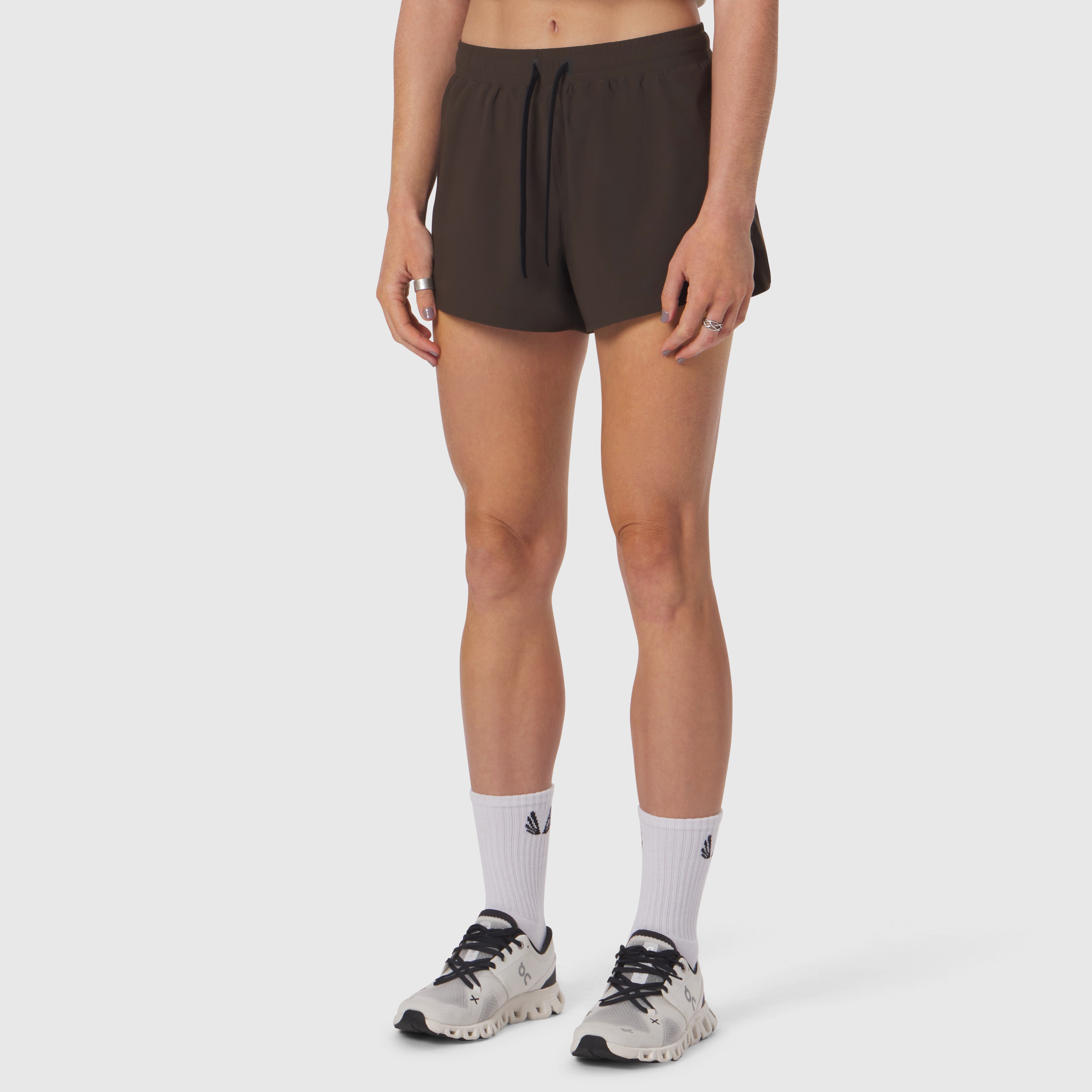 Tetra-Lite® Linerless Short in Dark Earth, modeled with white socks and trail running shoes