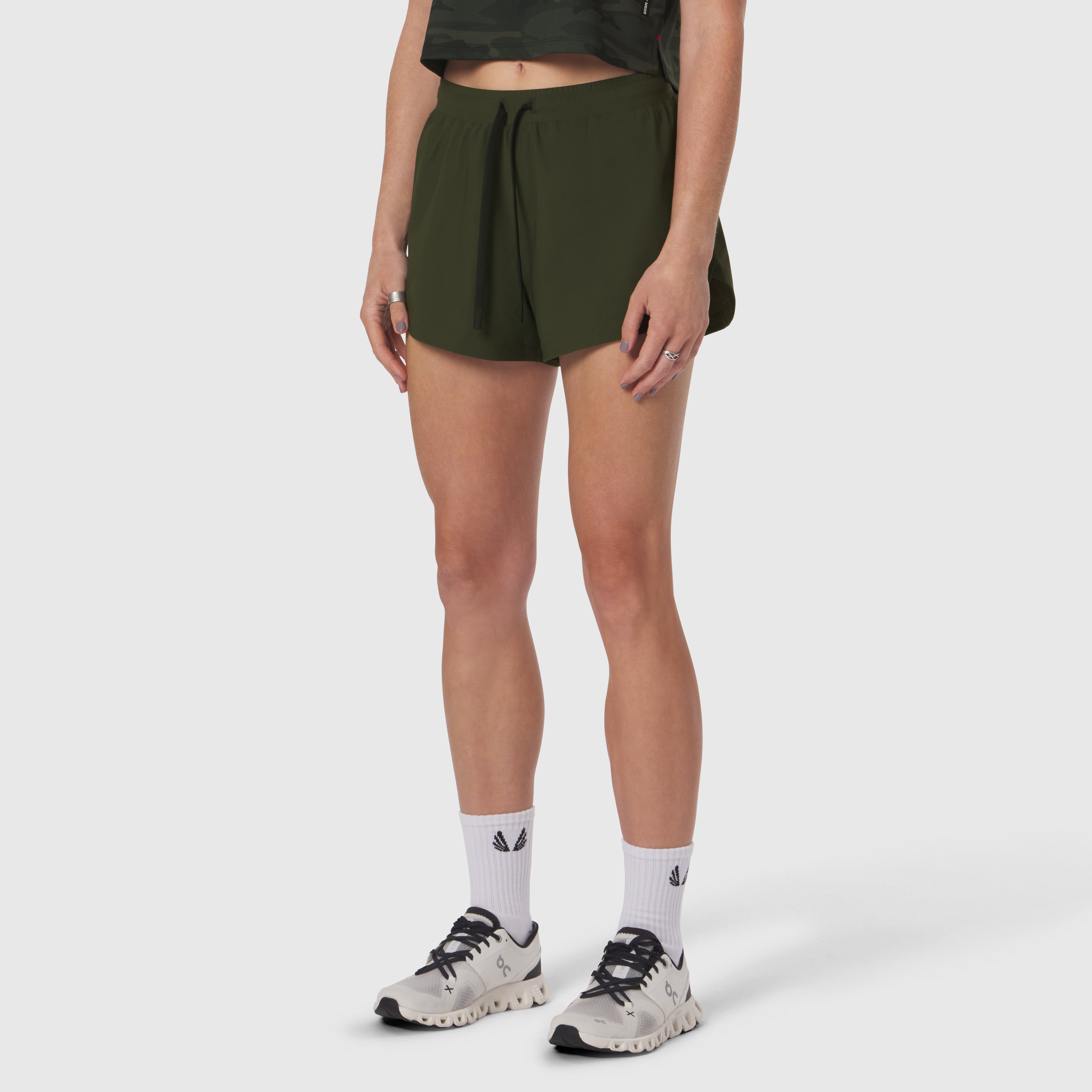 Tetra-Lite Linerless Short in olive worn by model with white socks and sneakers, front view