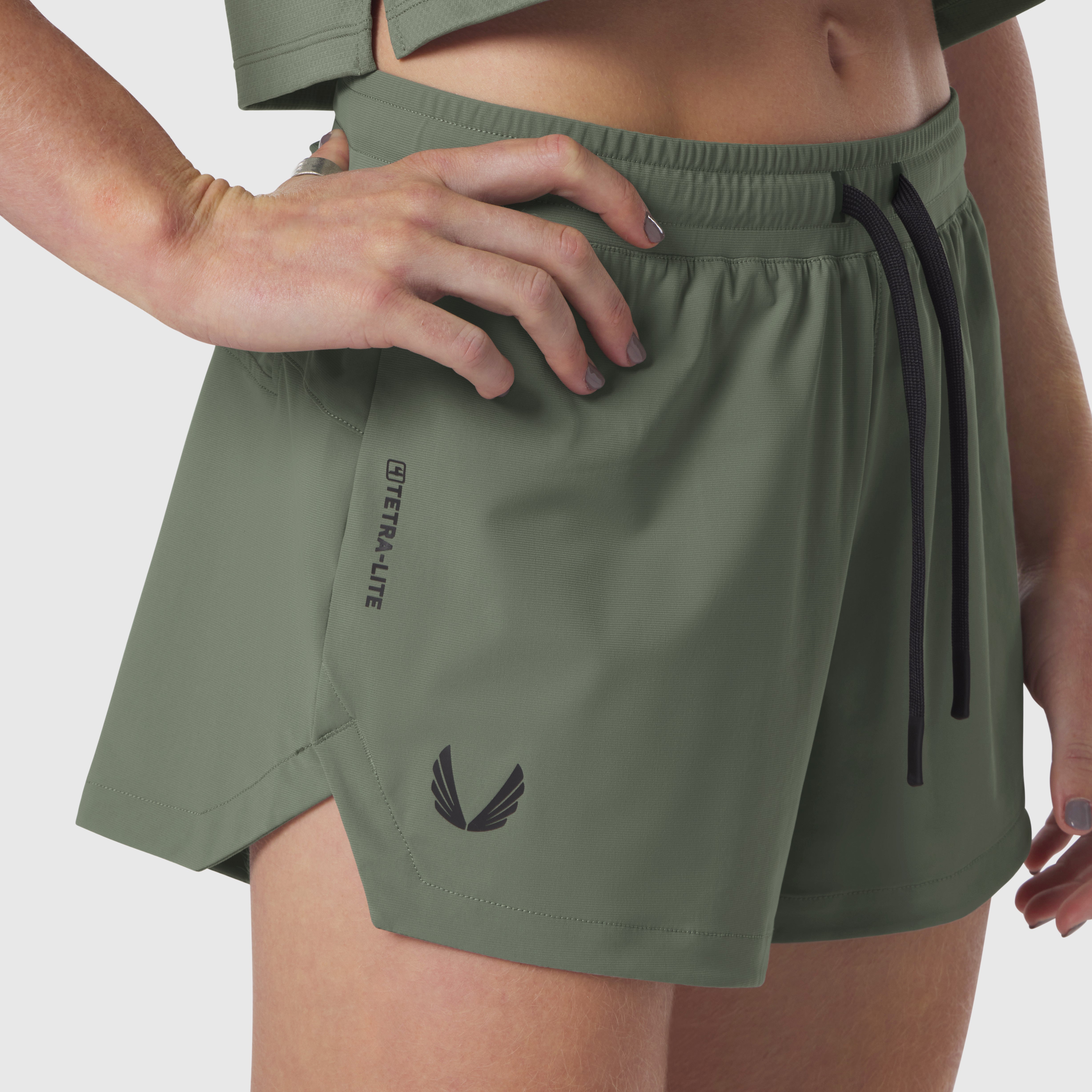Tetra-Lite Linerless Short in sage, worn by model showing front detail and fit