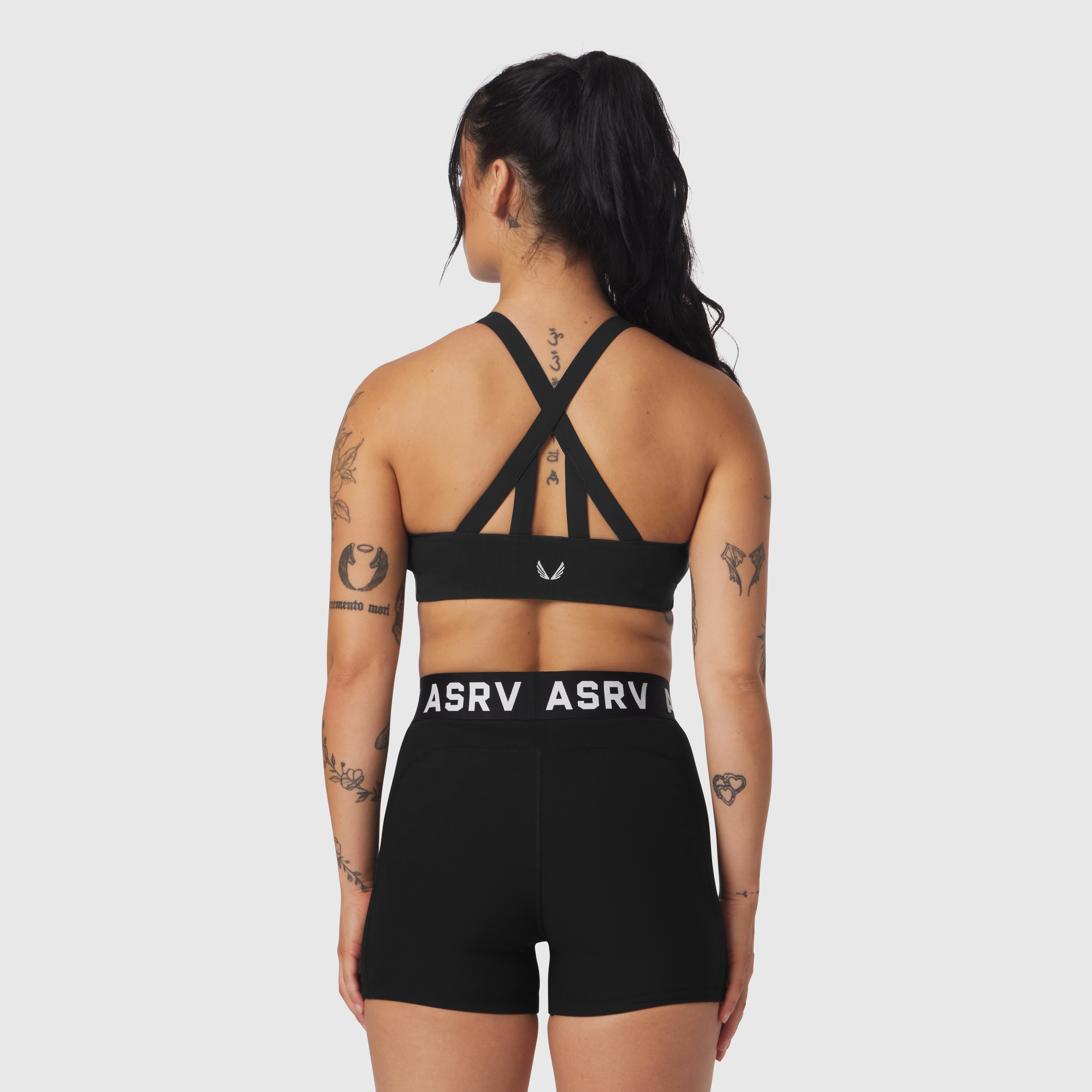 Black Lycra Hybrid Sports Bra worn by model, back view showing cross-strap design