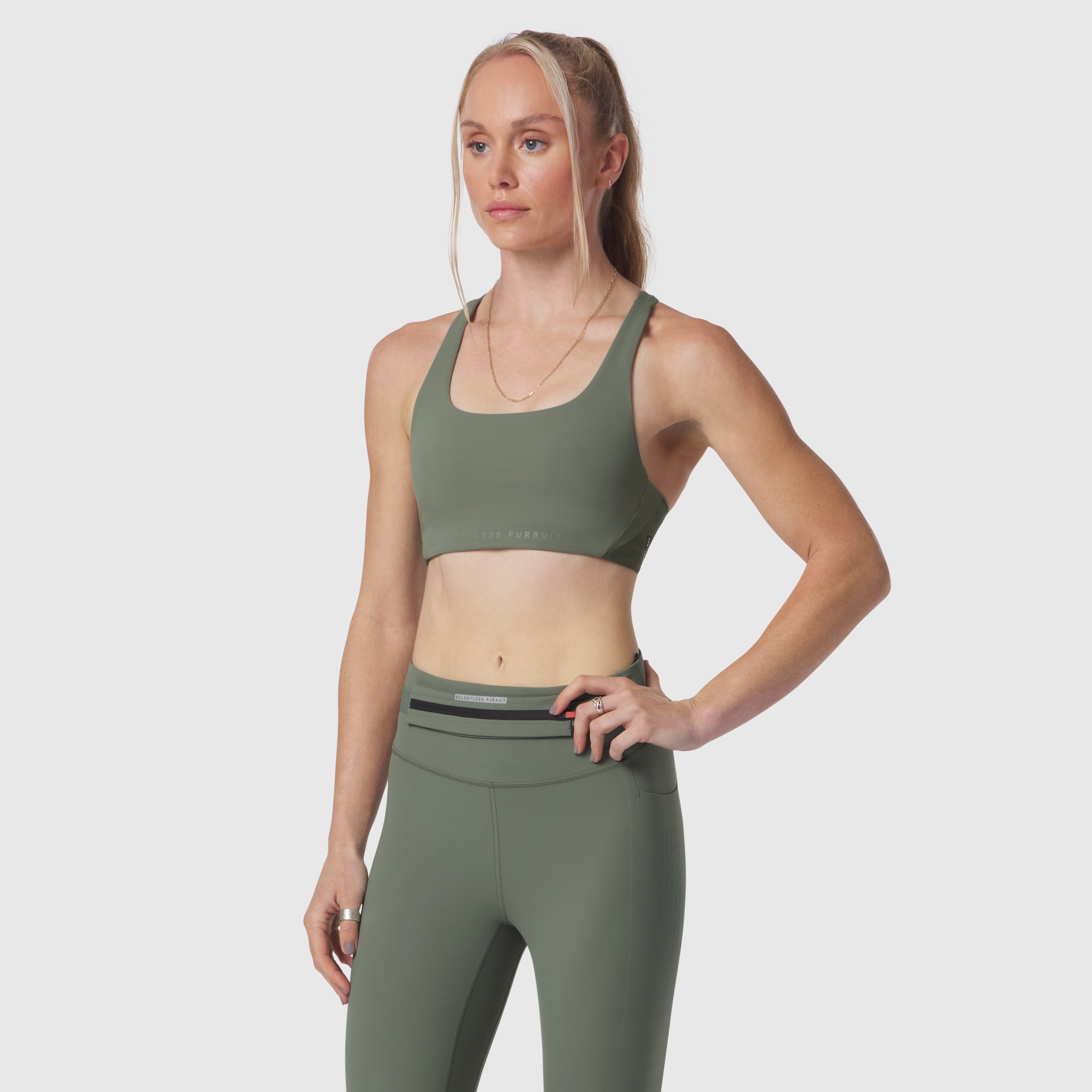 W039 Lycra Hybrid Sports Bra in sage, worn by model, front view