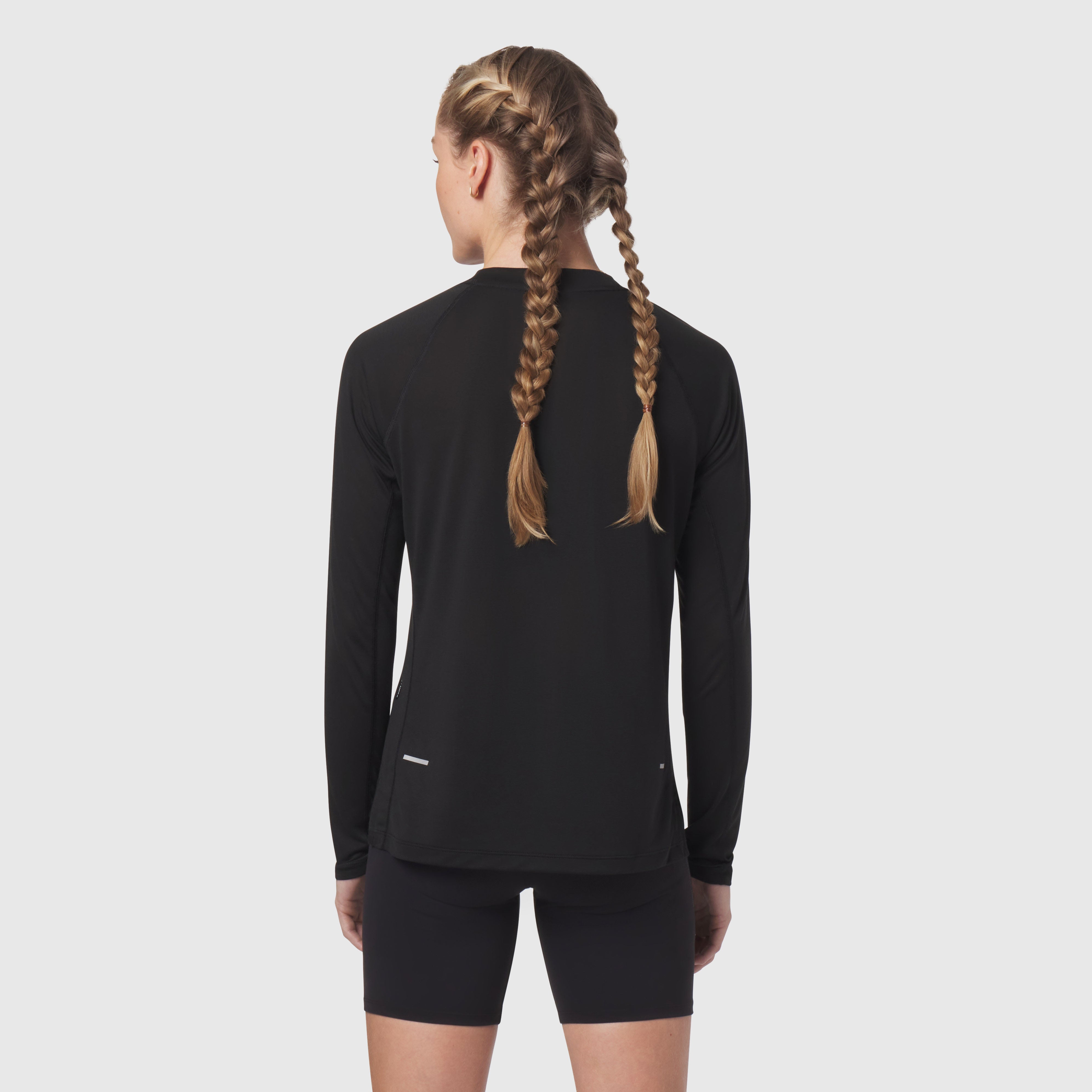 Polartec Delta longsleeve in black, back view on model with braided hair