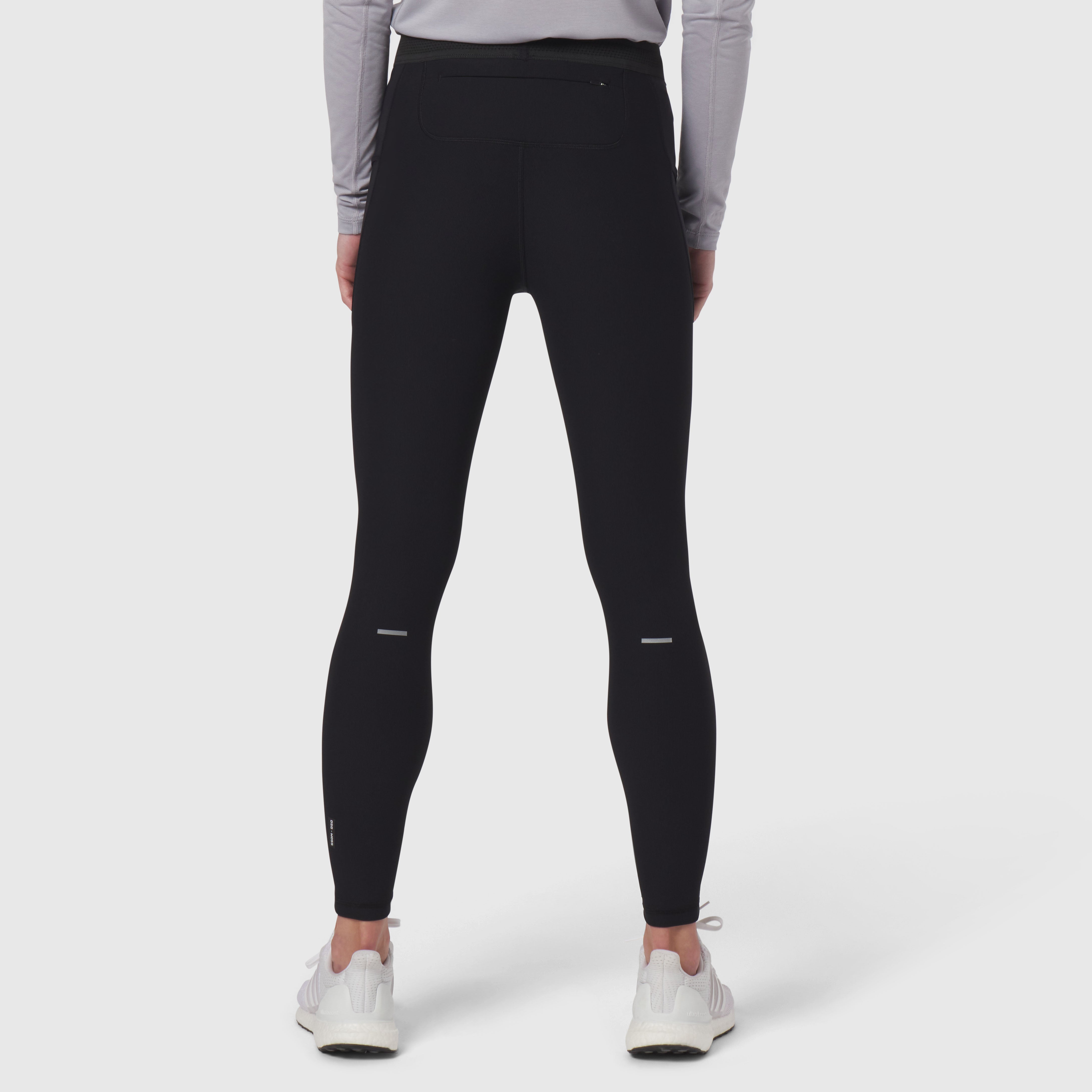 Black Lycra Ribbed Running Tight worn by model from behind, showing fitted silhouette and reflective details