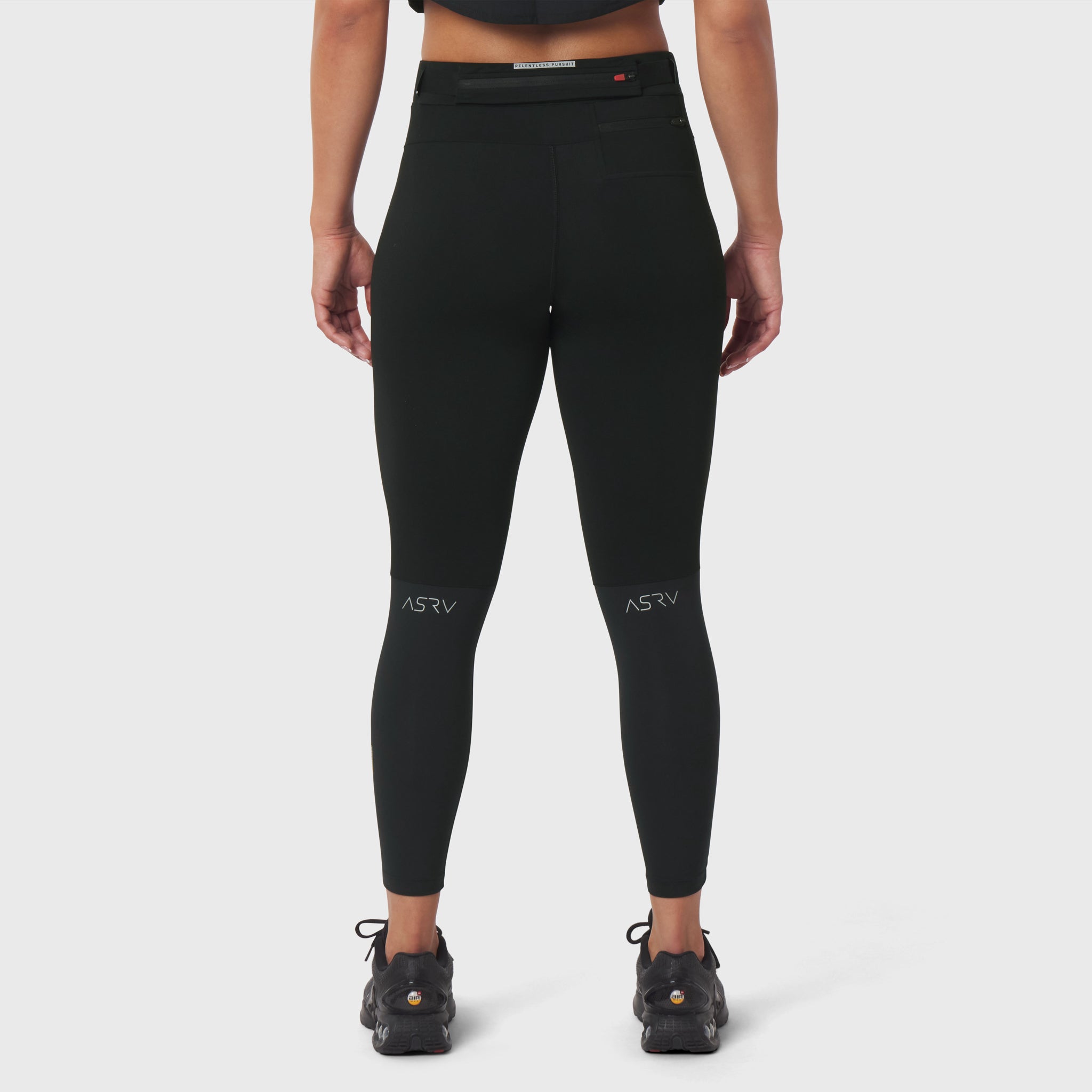 W059 Hybrid Belt-Pack Run Legging in black, back view on model with hiking boots