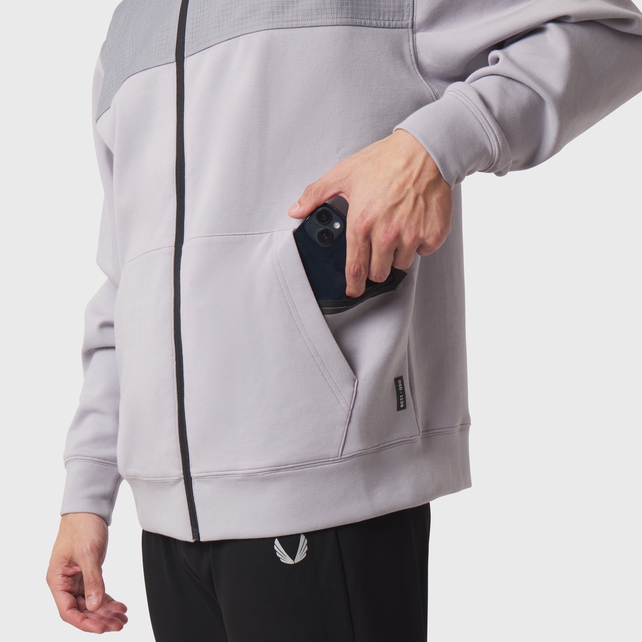 Dri-Core Sidelock Full Zip hoodie in slate grey, model holding phone in pocket