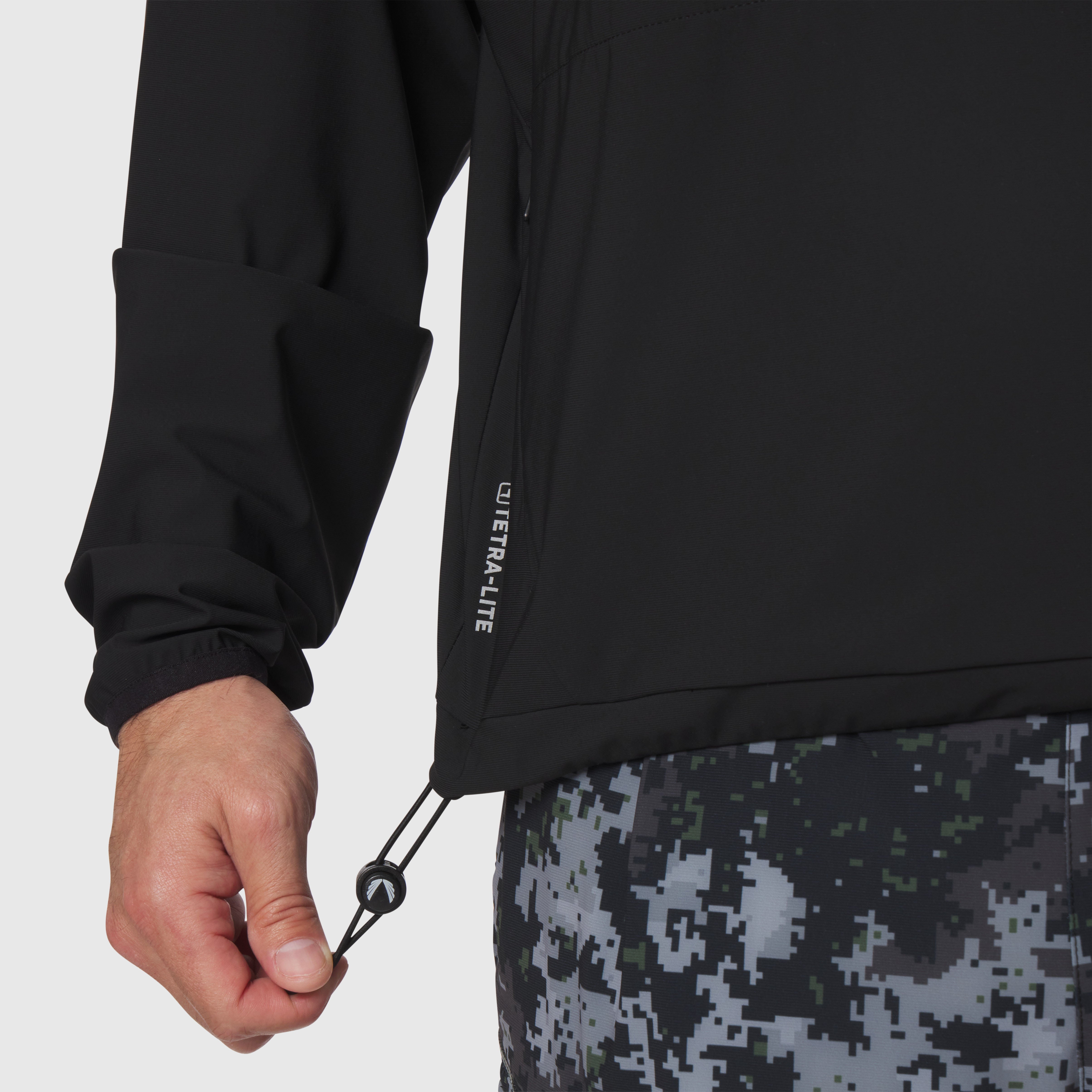 Tetra-Lite Blade Collar Zip Jacket in black, worn with hand adjusting drawcord detail
