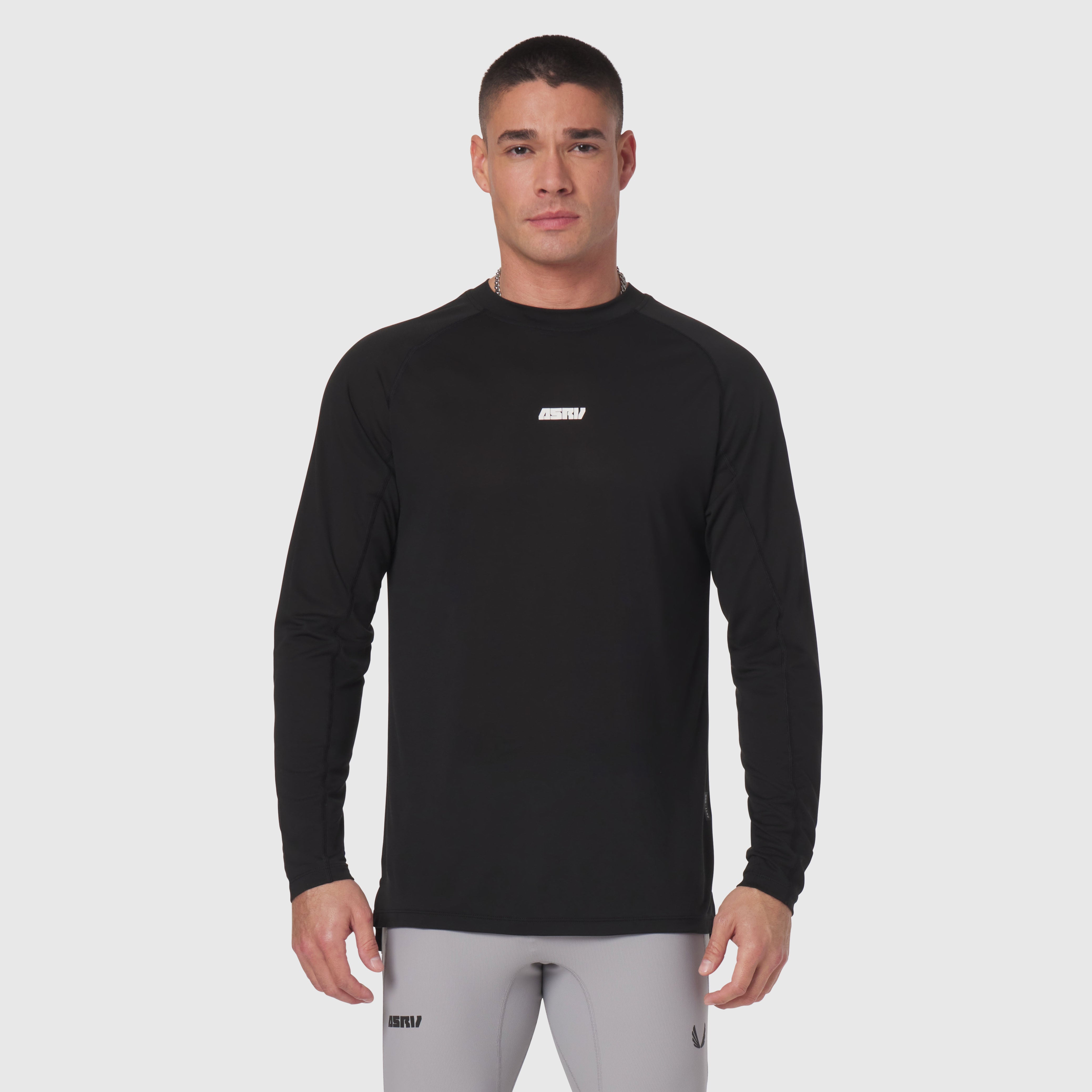 Polartec® Delta longsleeve in black, worn by model with gray joggers, front view
