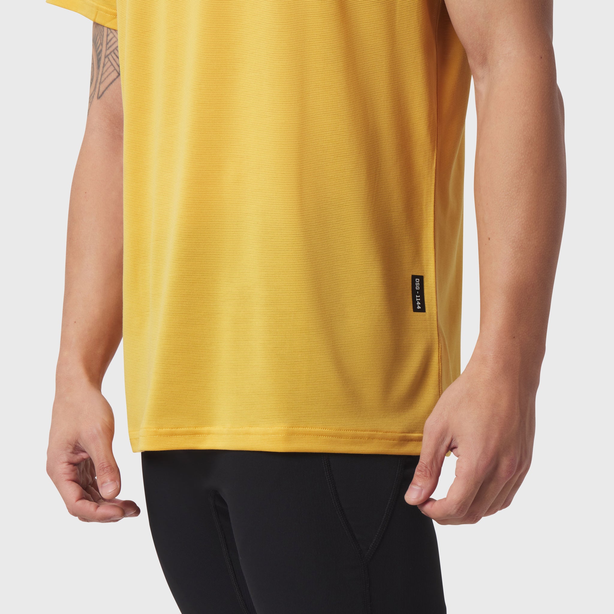 Polartec® Delta Training Tee in amber yellow worn by model, front side view