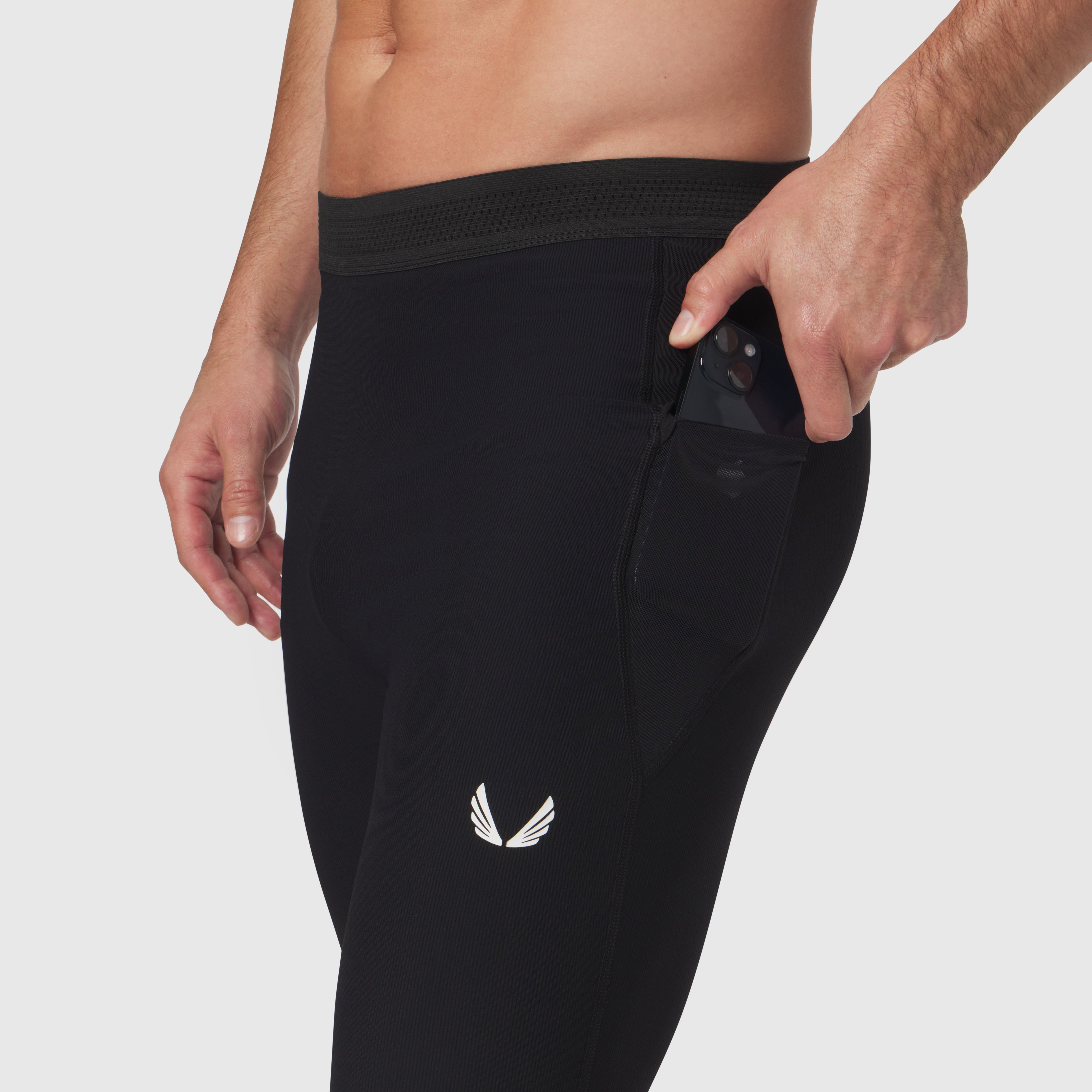 Black Lycra® Ribbed Running Tight worn by model, side view with hand in pocket
