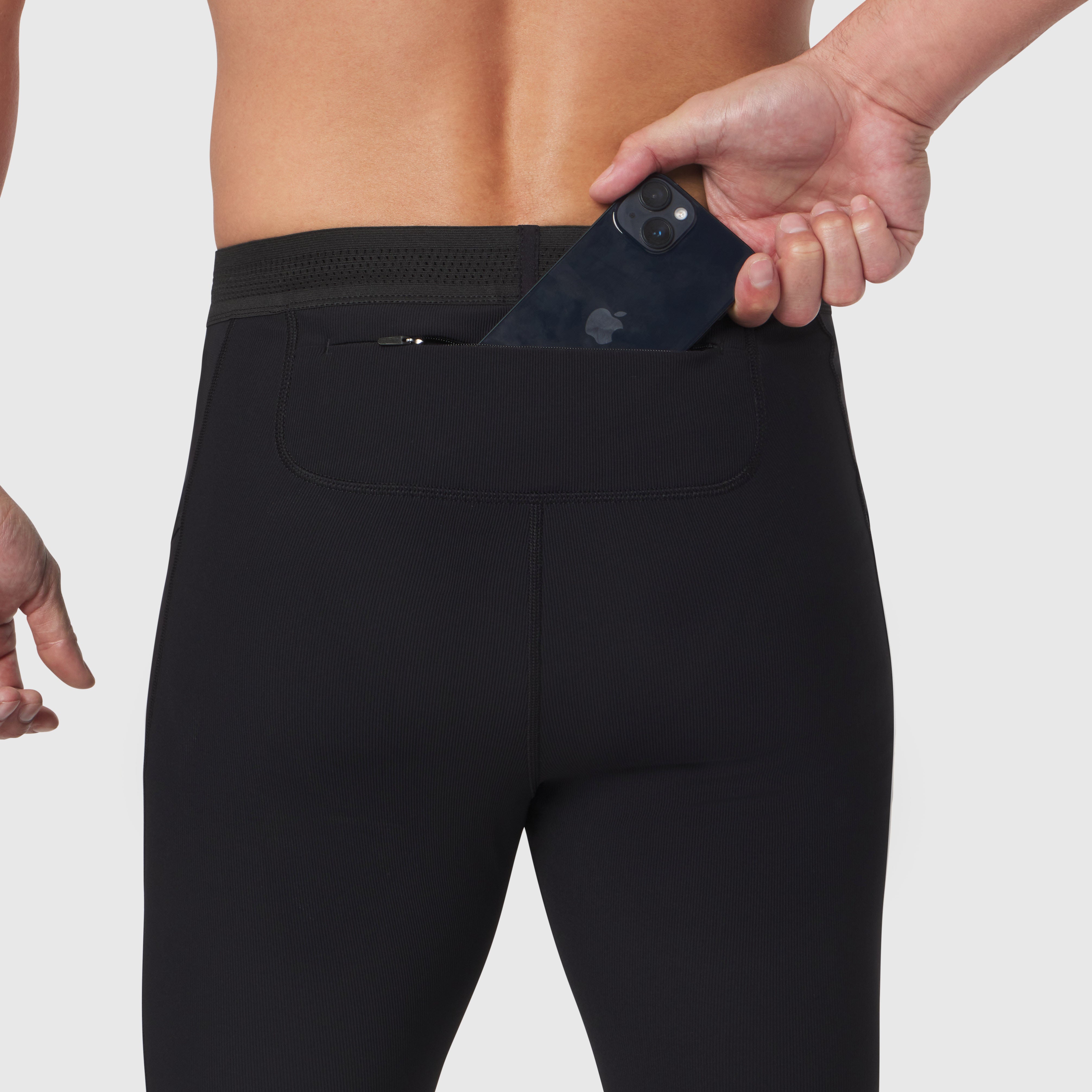 Black Lycra® Ribbed Running Tight worn by model, demonstrating back pocket with phone storage