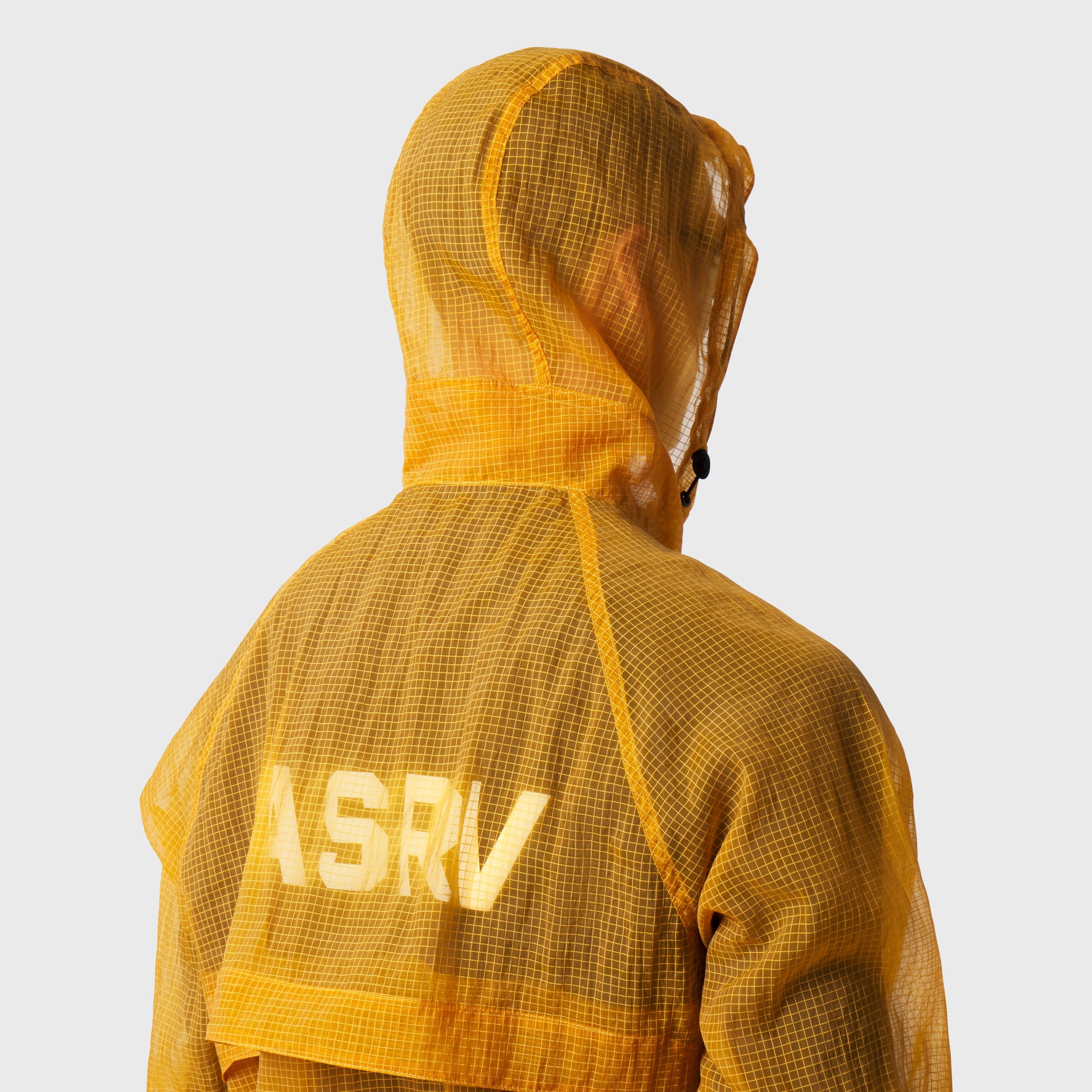 Weather-Ready Transparent Ripstop Shell Jacket in amber worn by model, back view with hood up