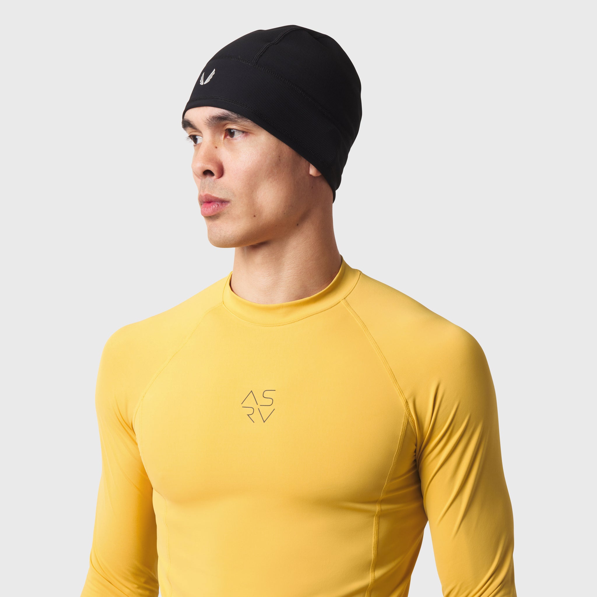 LYCRA® ADAPTIV Baselayer Longsleeve in amber yellow, worn by model facing right
