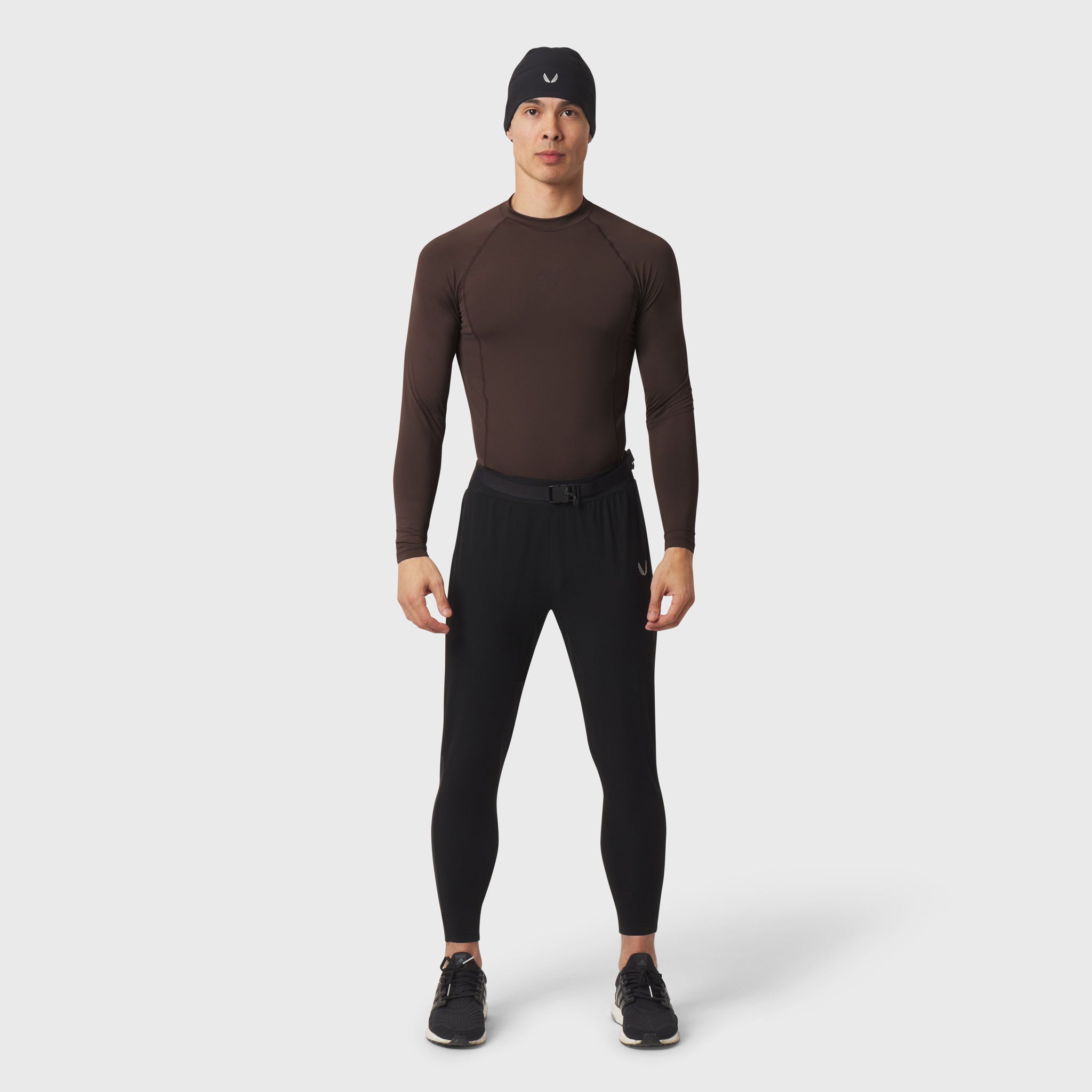 LYCRA® ADAPTIV Baselayer Longsleeve in dark brown, worn with black leggings, front view