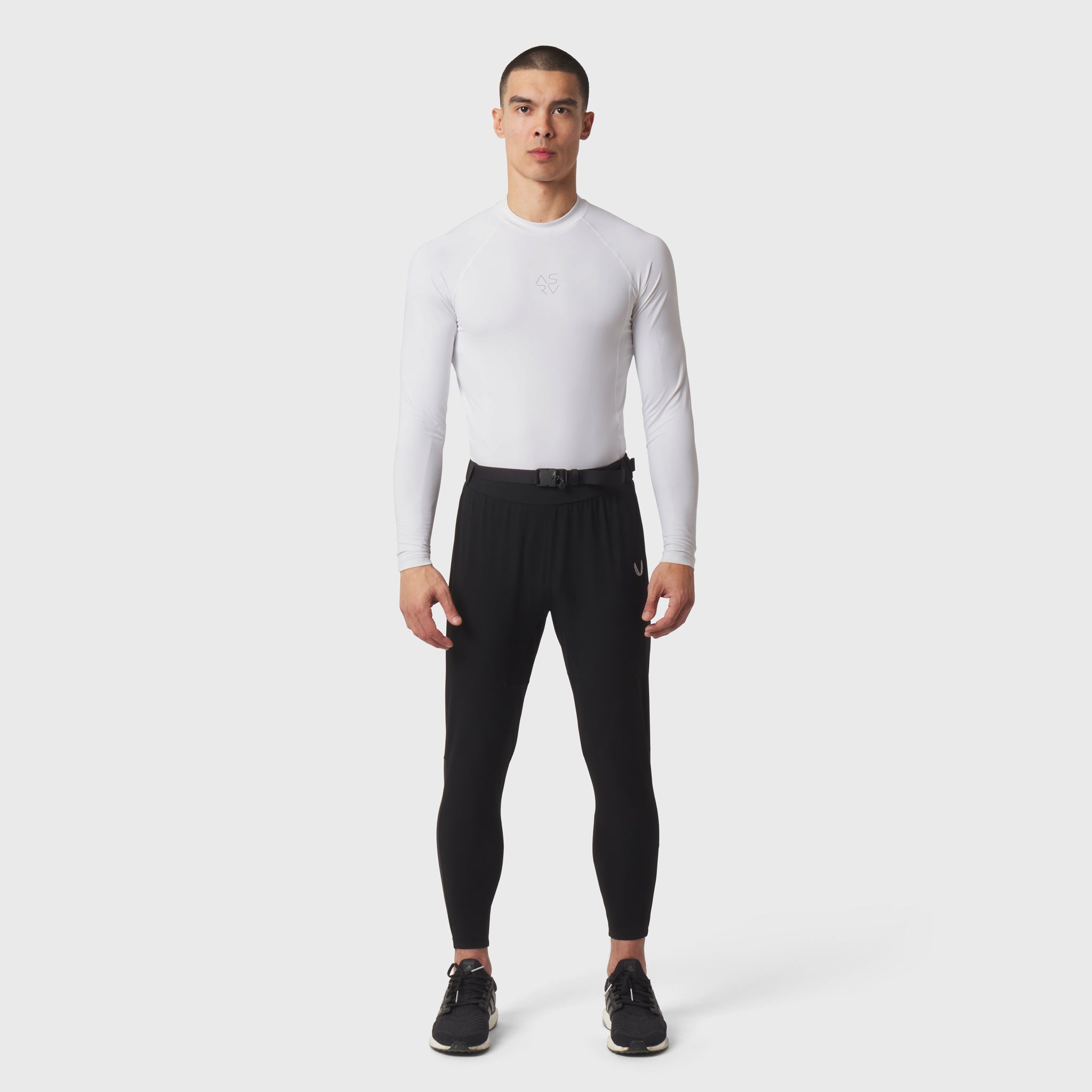 White LYCRA® ADAPTIV Baselayer Longsleeve worn with black leggings, front view
