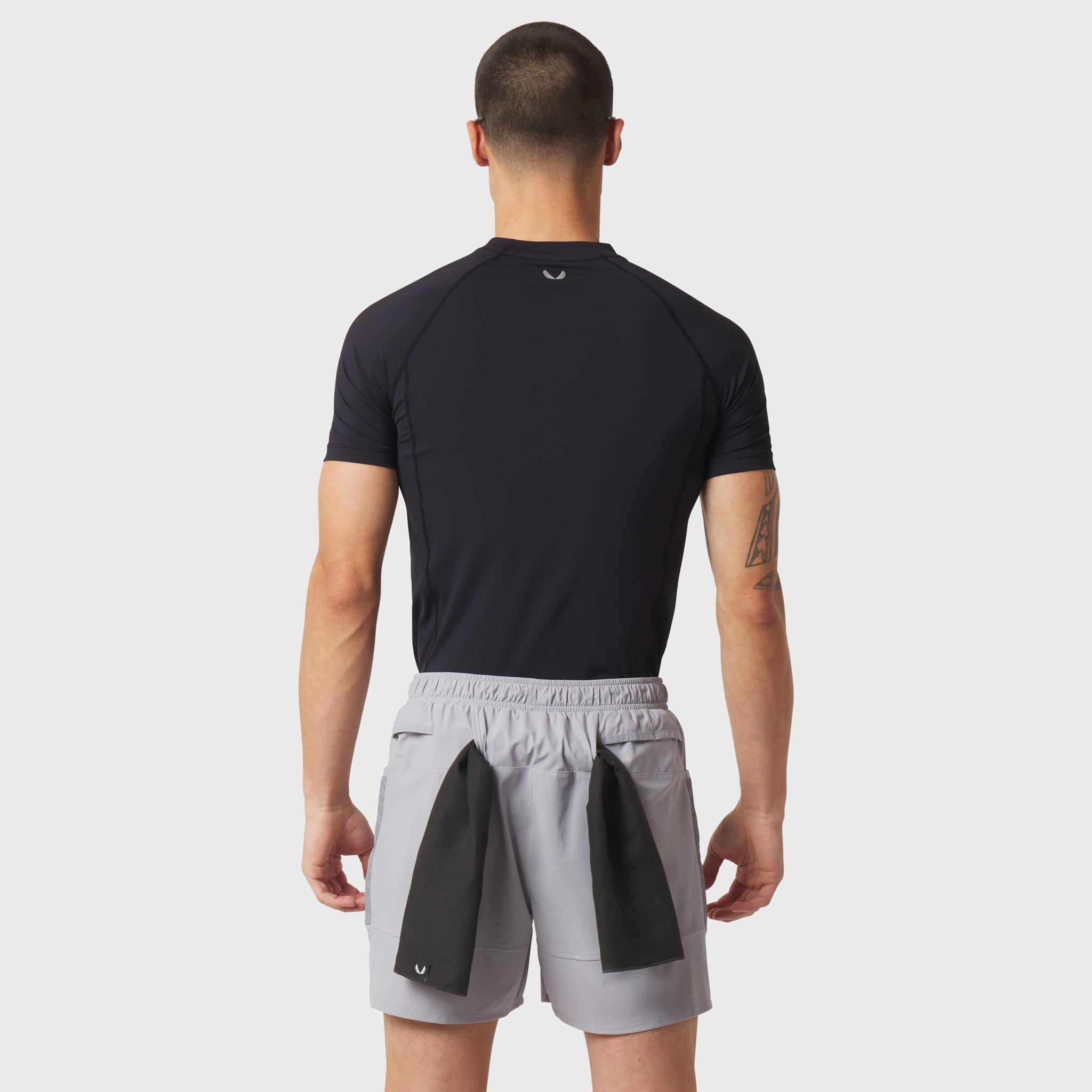 LYCRA® ADAPTIV Baselayer Shortsleeve in black, worn by model from back view