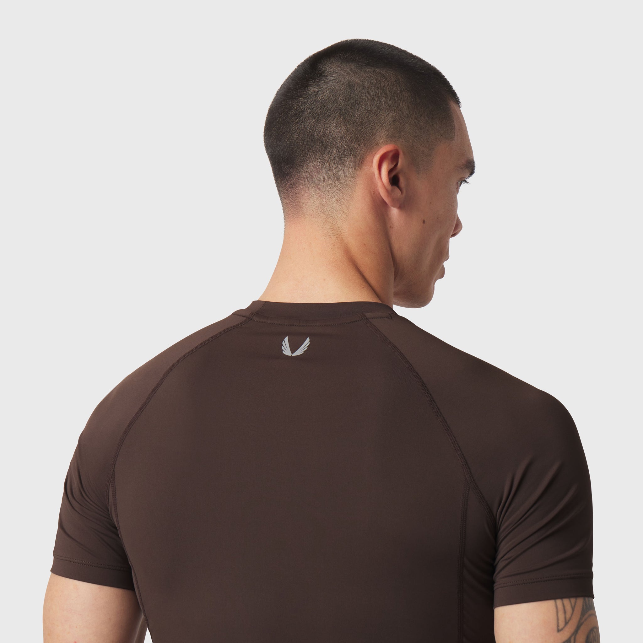 LYCRA® ADAPTIV Baselayer Shortsleeve in Dark Earth, back view on model