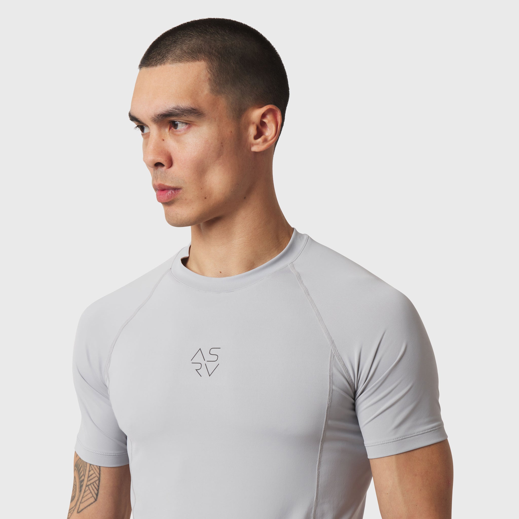 LYCRA® ADAPTIV baselayer short-sleeve tee in slate grey, worn by model, front-facing side view