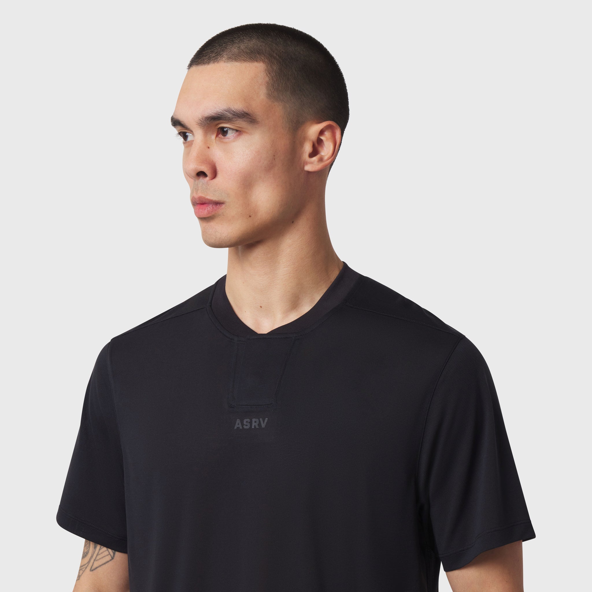 Black Polartec® Delta Polo worn by model, front side profile view