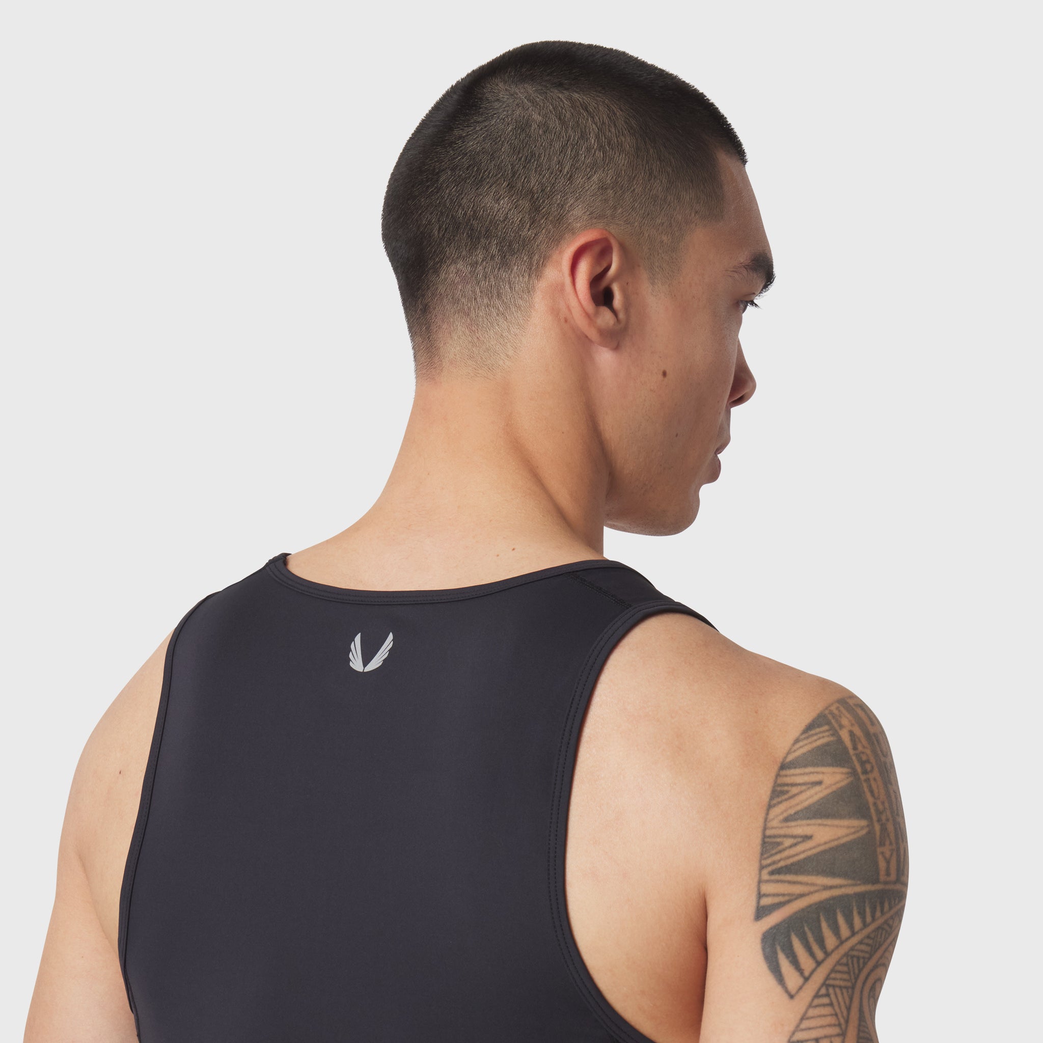 Black LYCRA® ADAPTIV Baselayer Tank worn by model, back view