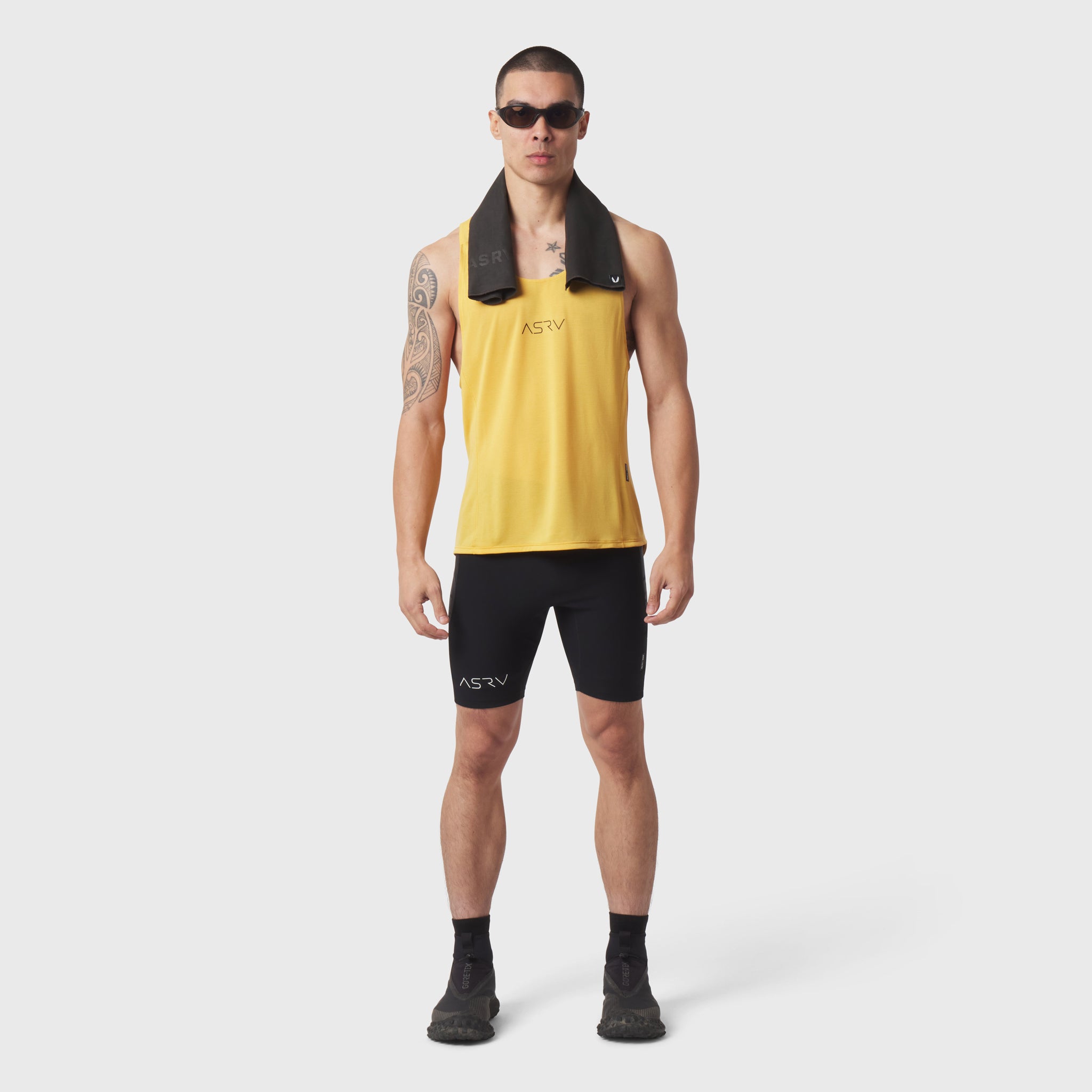 Polartec® Delta Singlet in amber yellow worn by male model with black shorts and towel