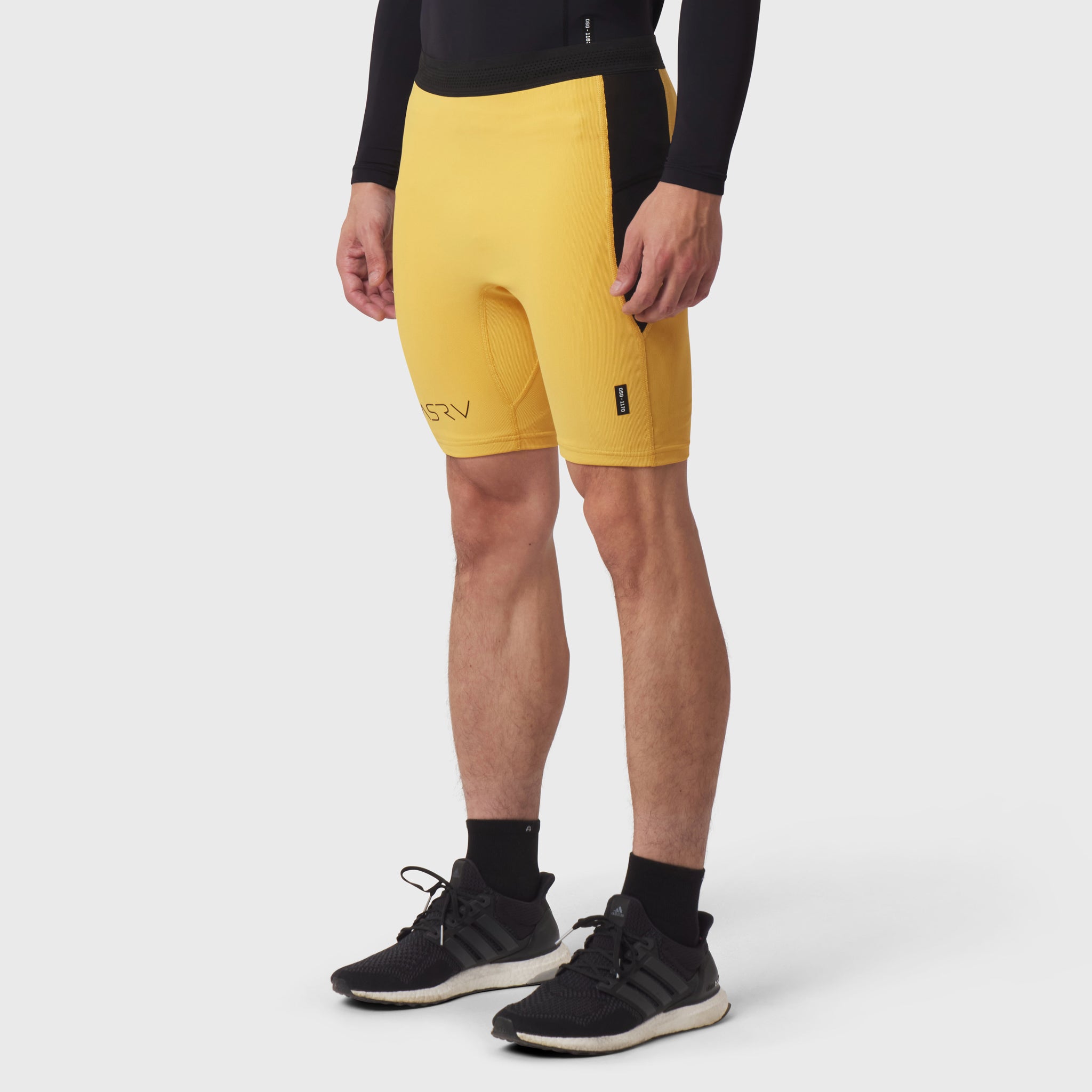 Lycra® Ribbed Run Half-Tight in amber yellow, worn by model, front view