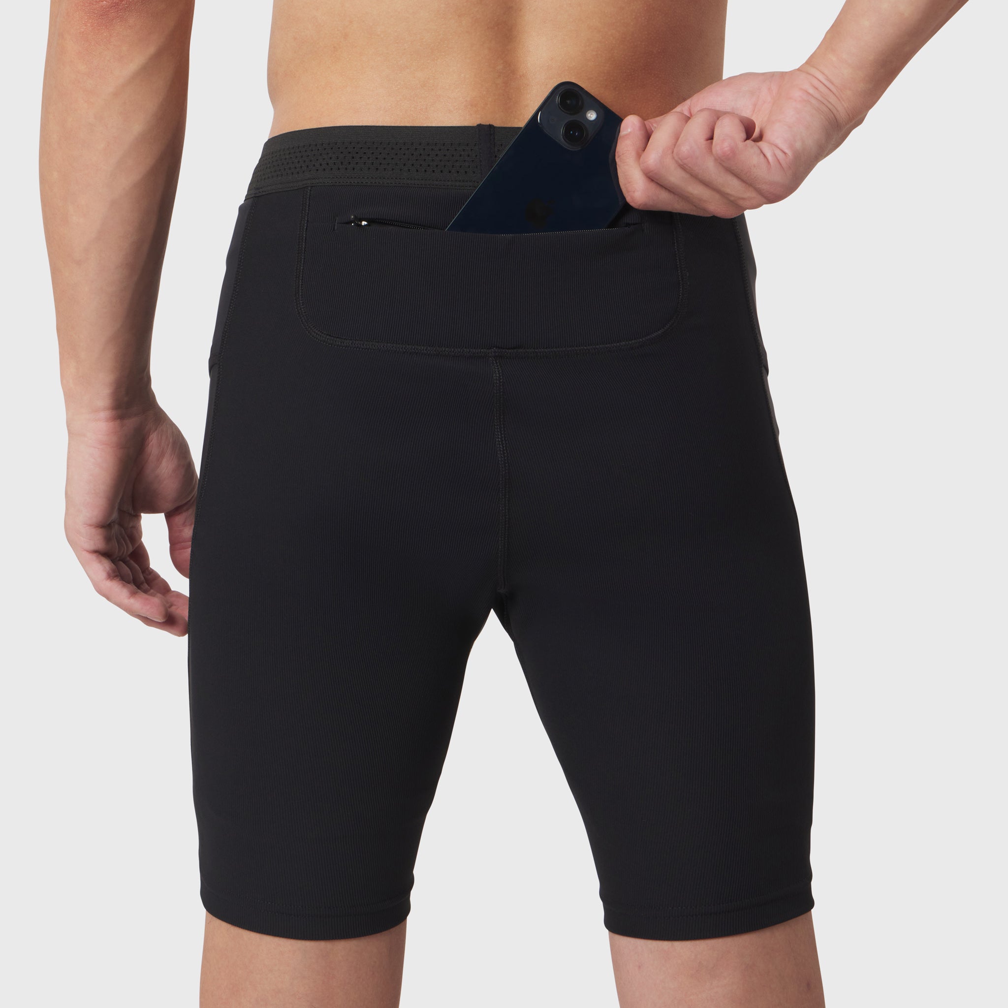 Black Lycra Ribbed Run Half-Tight worn by model, back view showing rear pocket with phone