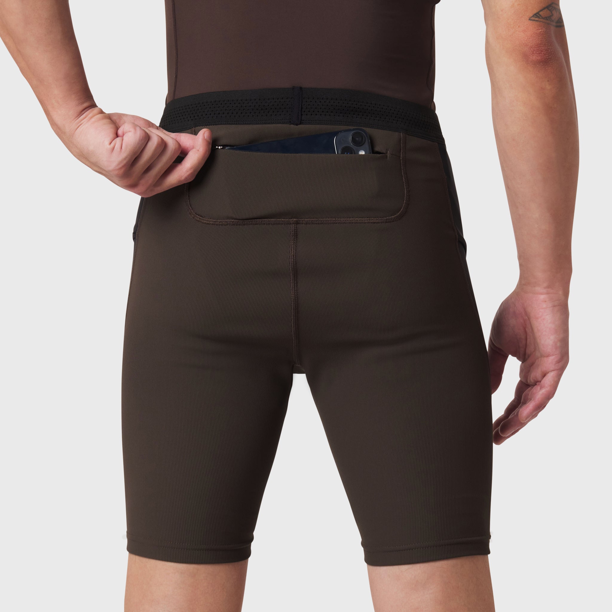 Lycra® Ribbed Run Half-Tight in Dark Earth, worn by model demonstrating back pocket detail