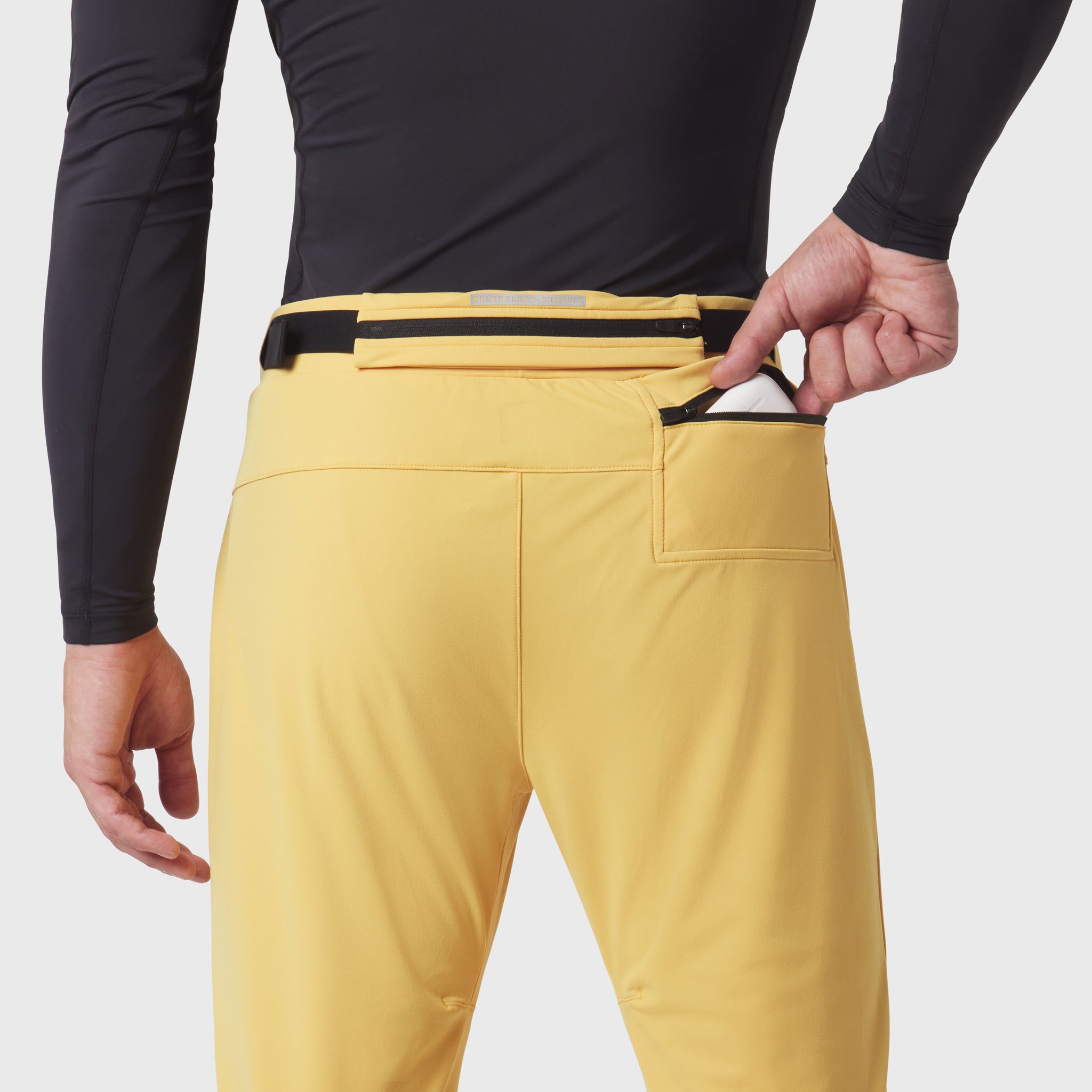 Hybrid Belt-Pack Run Jogger in Amber, back view with model wearing and adjusting belt