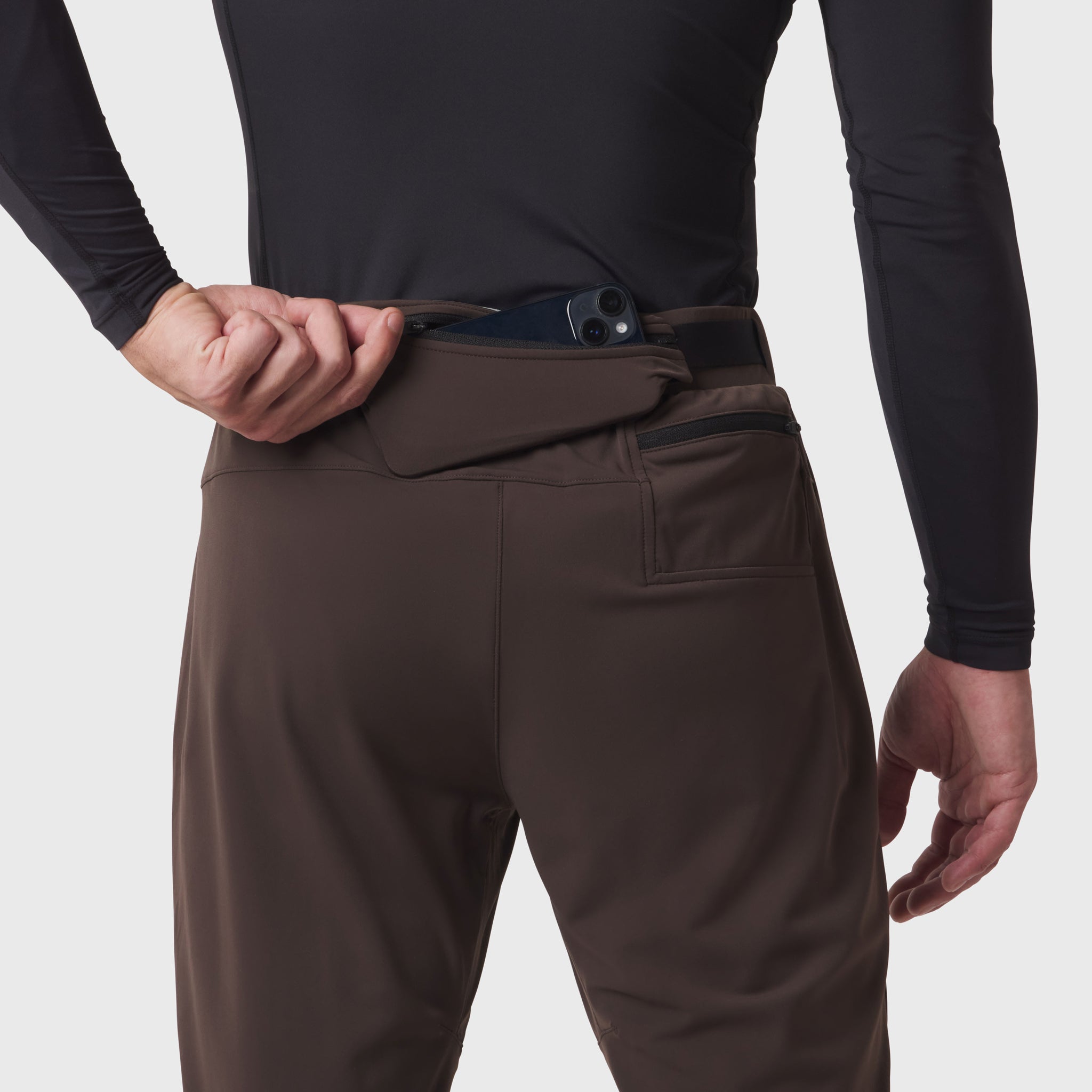 Hybrid Belt-Pack Run Jogger in Dark Earth, worn by model showing waistband detail with integrated belt pack