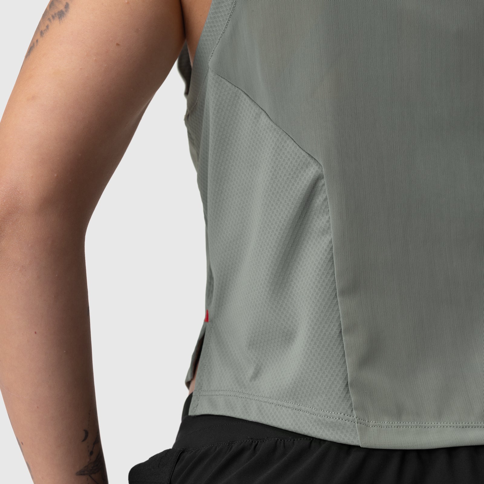 AeroSilver Cropped Training Tank in sage worn by model, side view